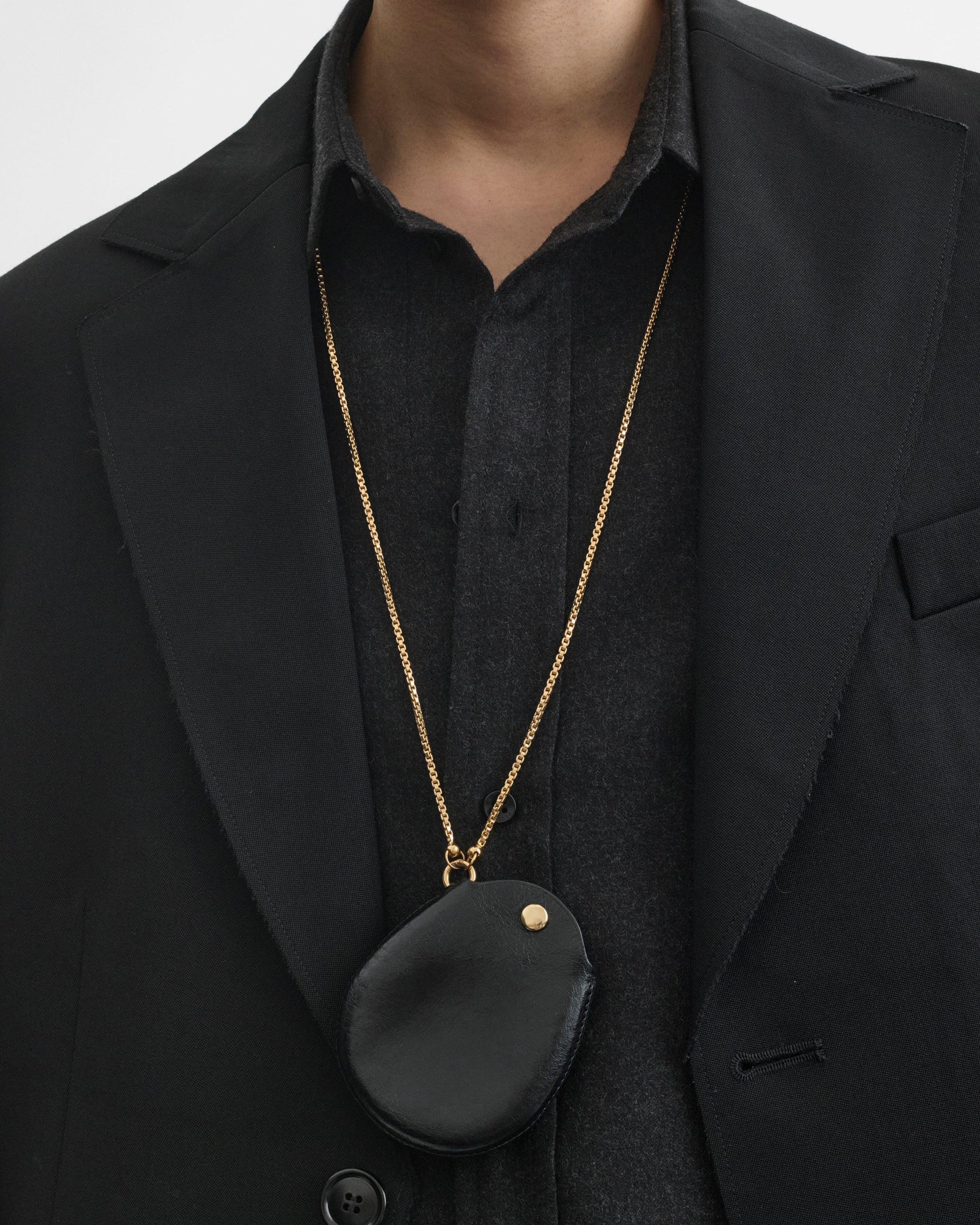 Front view of model wearing Pouch Pendant in black leather
