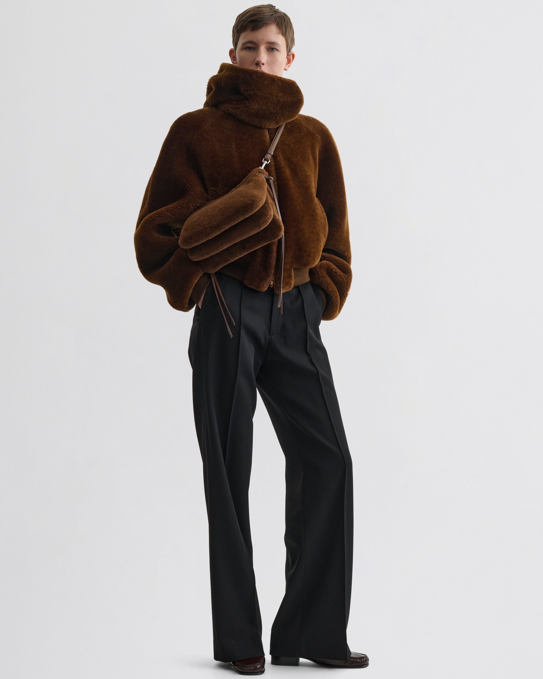 Front view of model wearing Small Gig Bag in ginger shearling