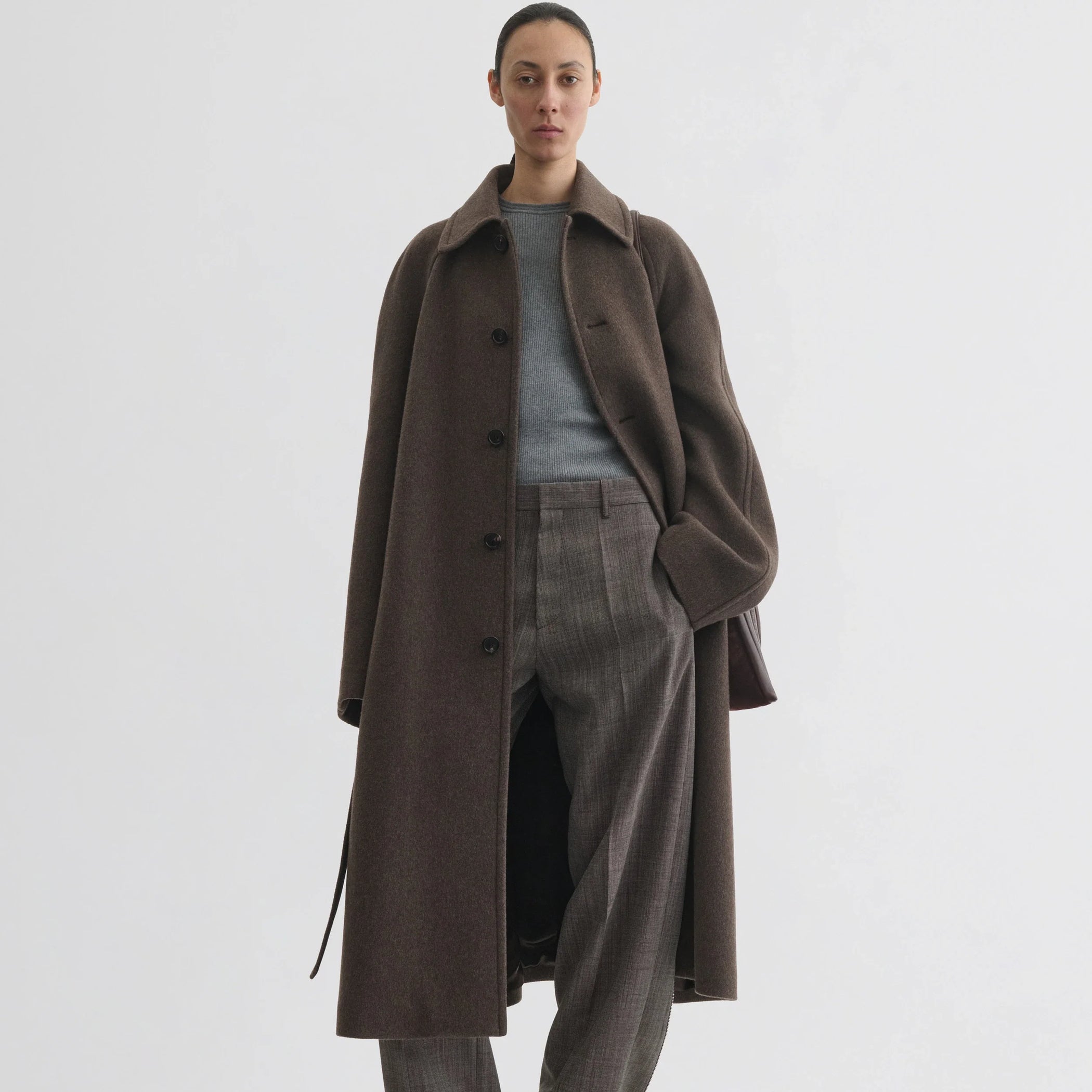 Front view of model wearing curve shoulder coat in brown cashmere.