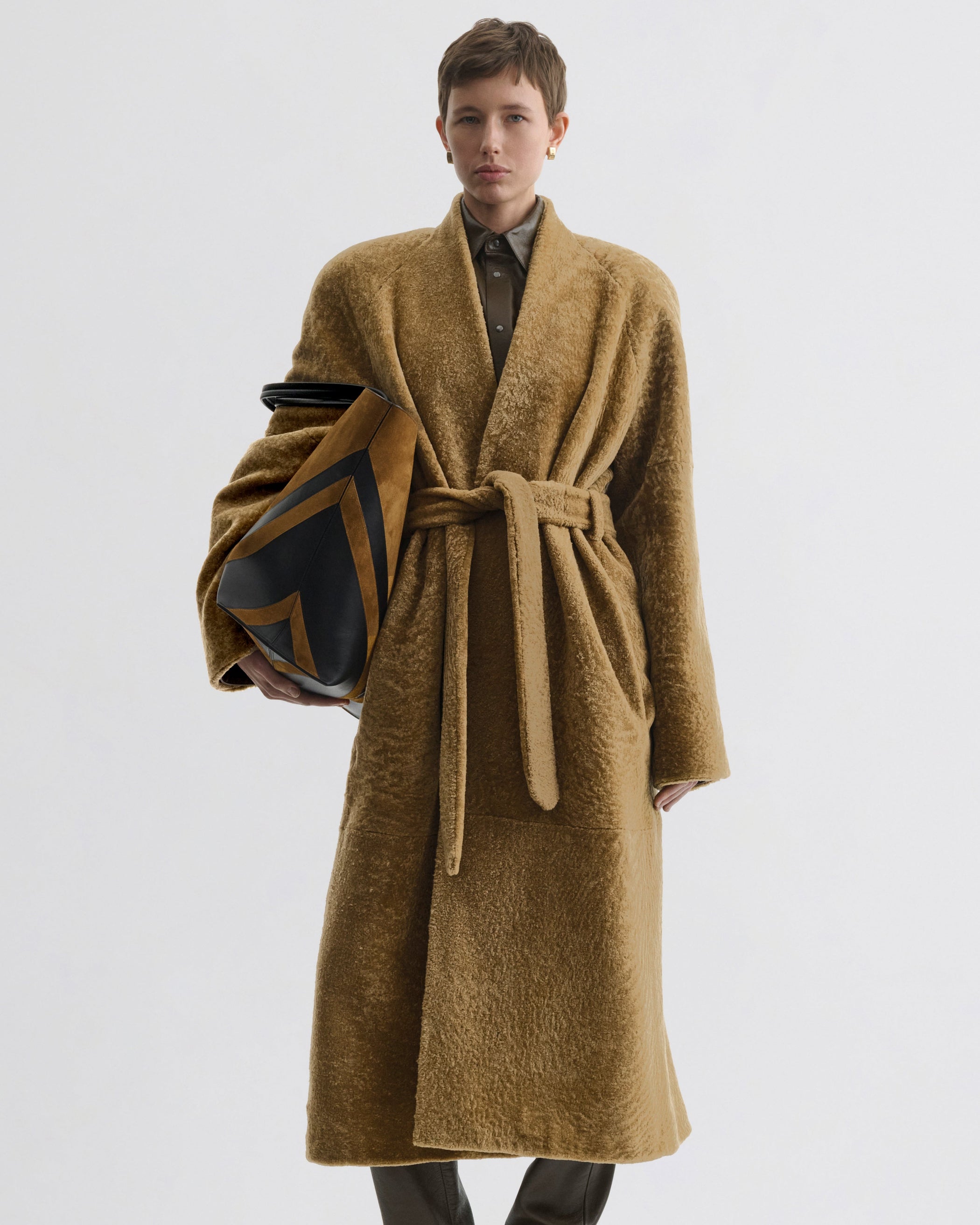 Front view of model wearing Shaved Robe Coat in tabac shearling