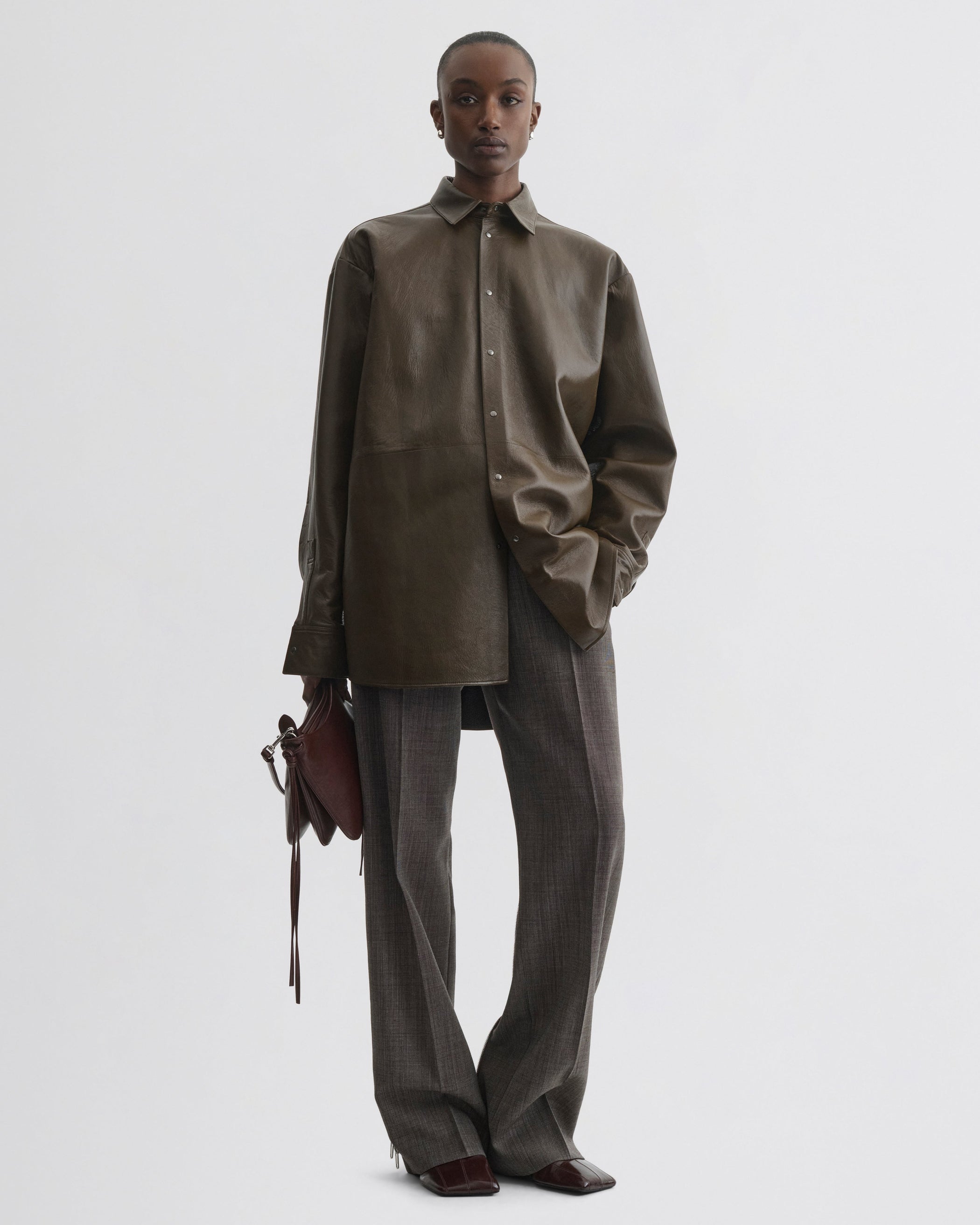 Front view of model wearing Split Zip Trousers in white dark brown wool