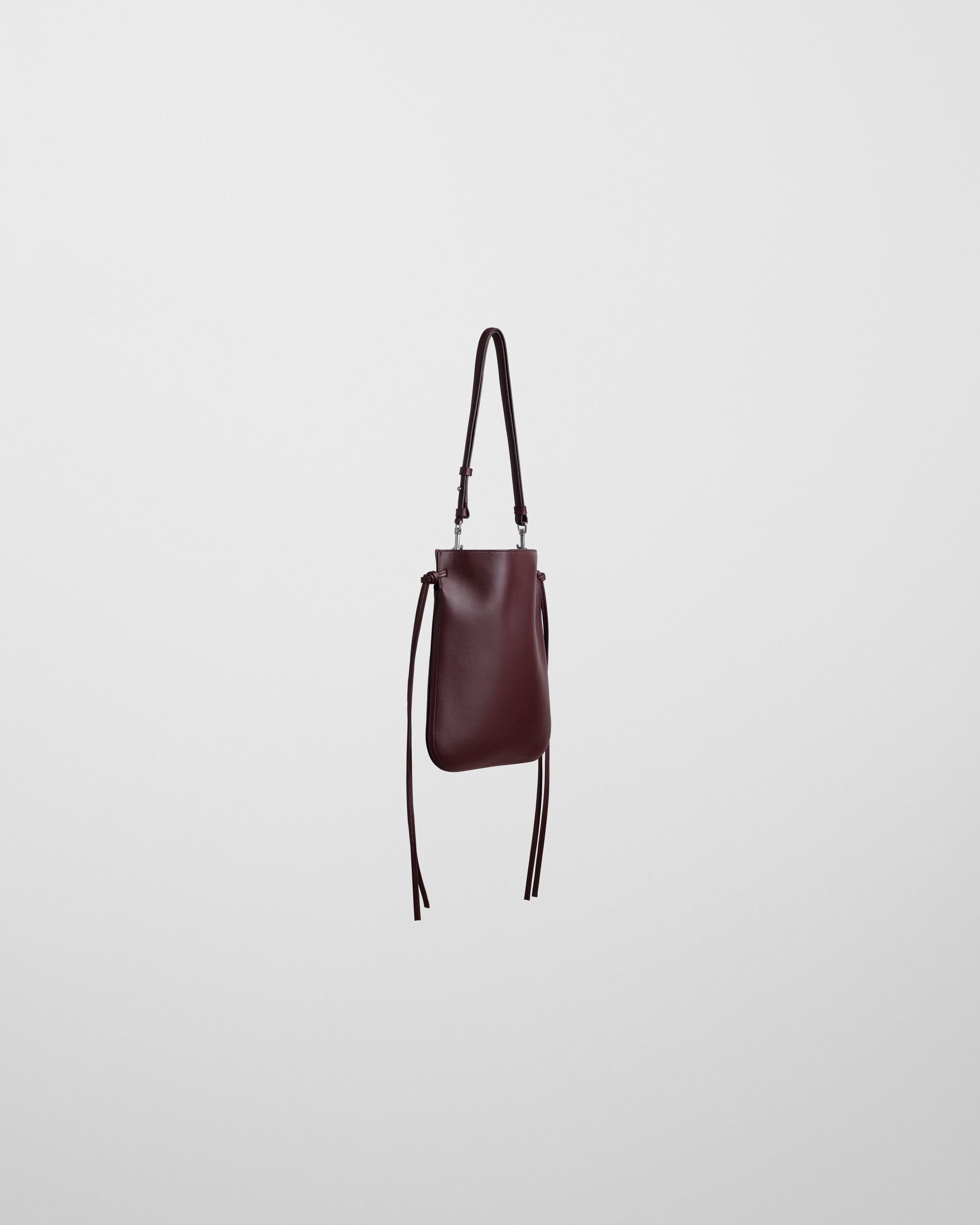 Side view of GIG POUCH BAG in oxblood leather