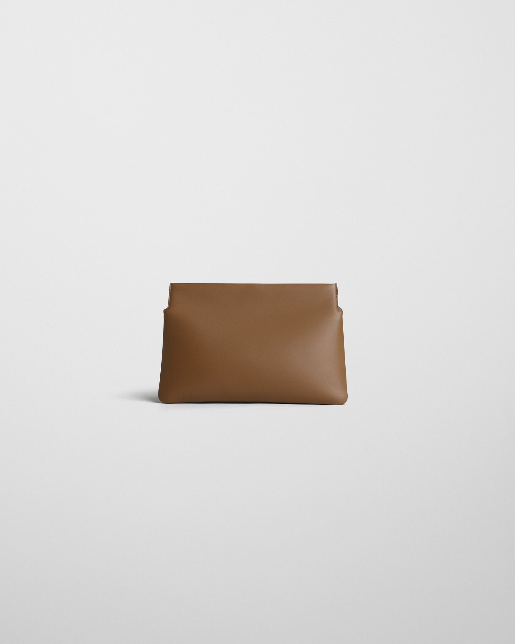 Back view of TRIPLEX CLUTCH in caramel leather.