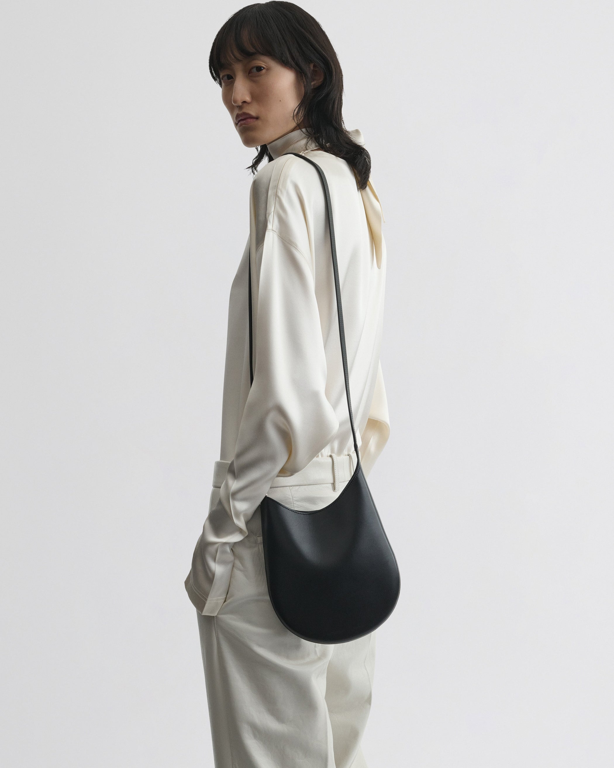 View of model wearing the Mini Bean Sling