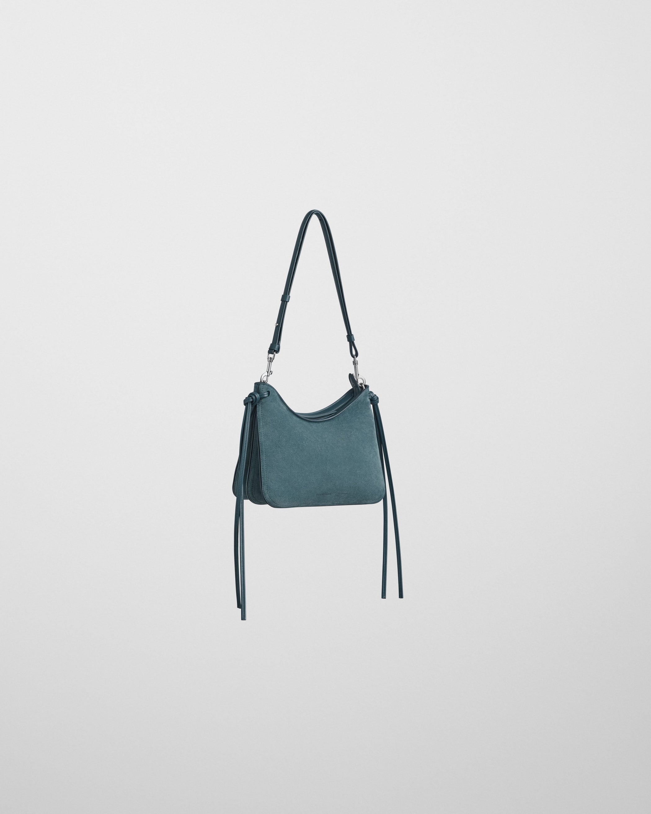 Angled front view of SMALL GIG BAG in denim blue suede