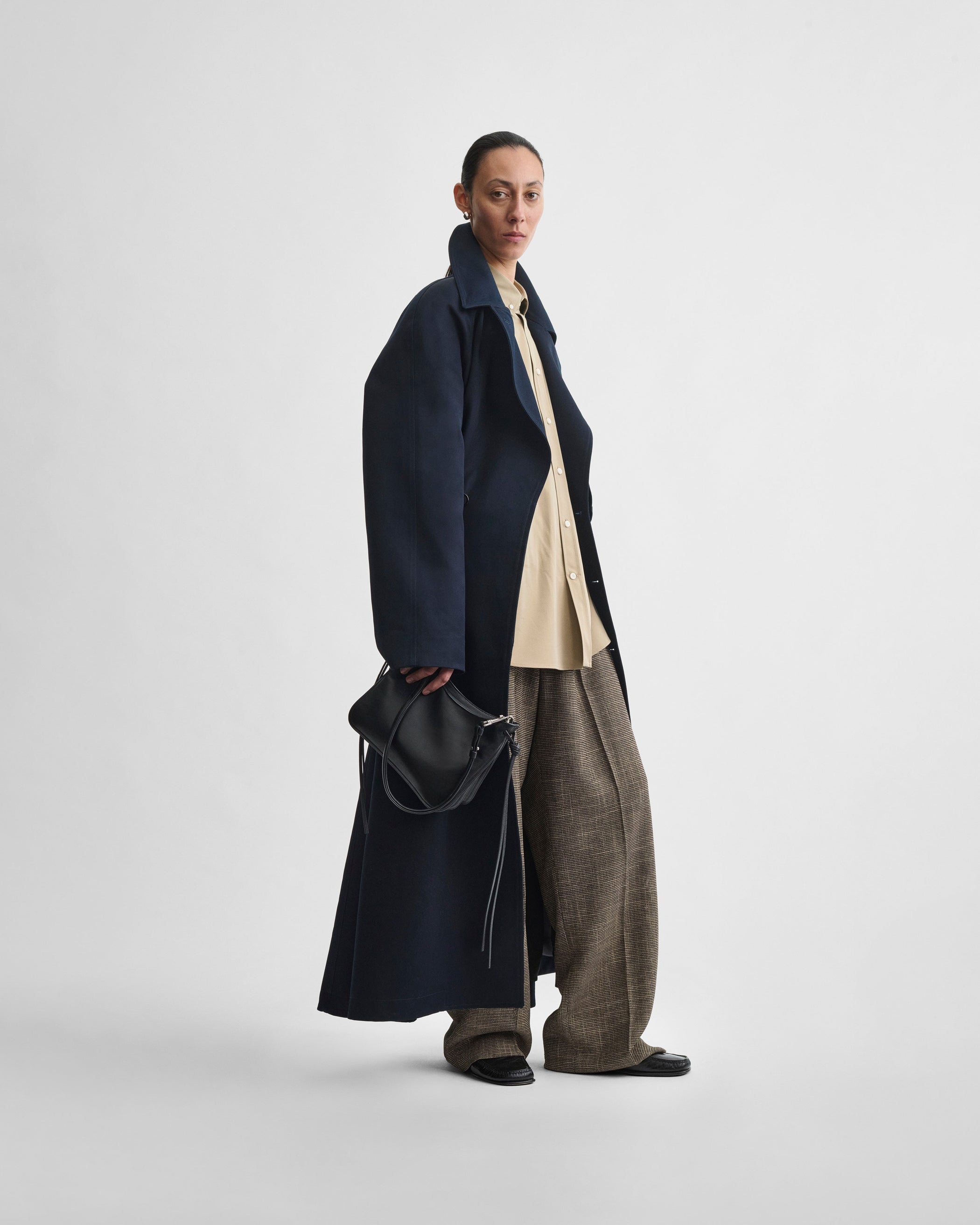 Model holding SMALL GIG BAG in black leather