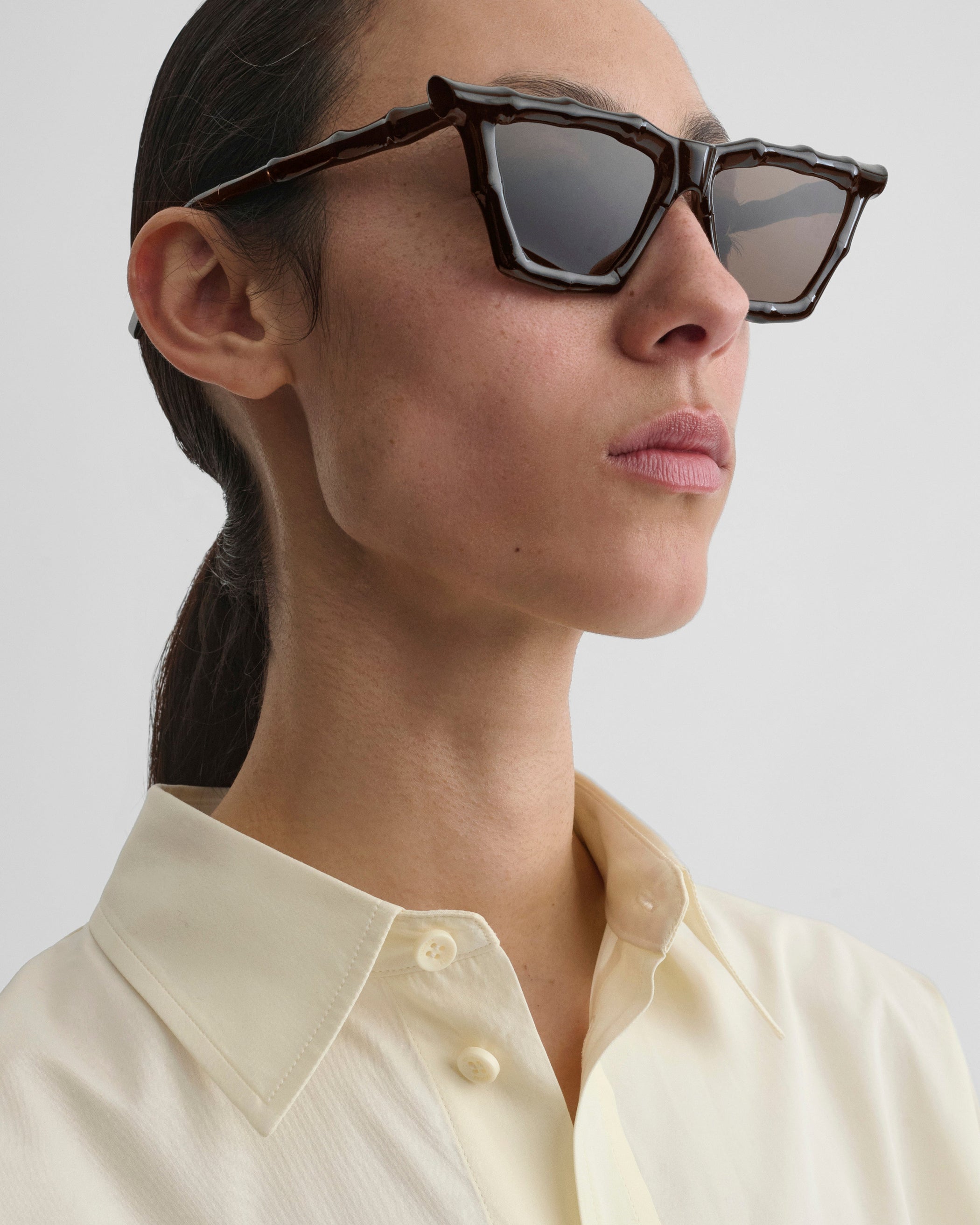 Side view of model wearing BAMBOO SUNGLASSES in dark brown rilsan