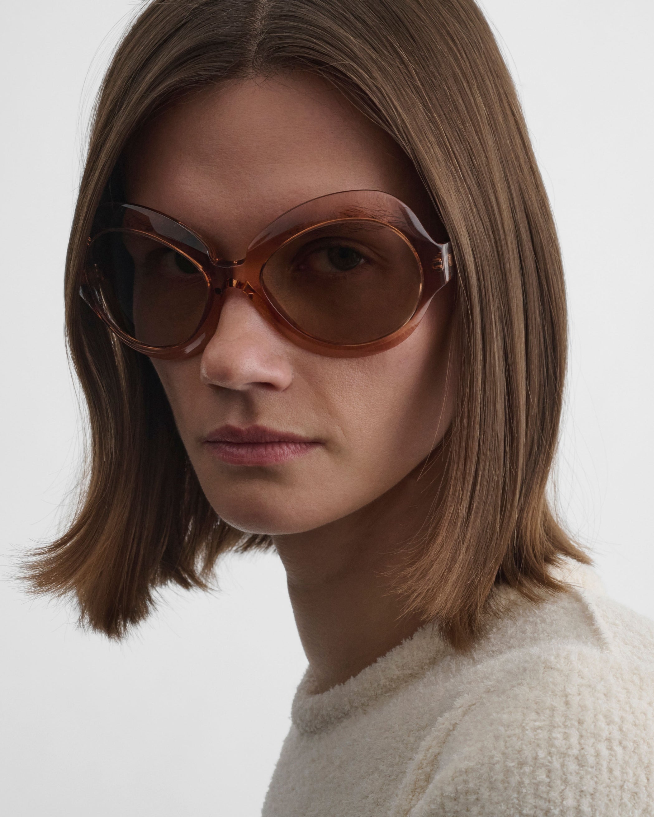 Side close up view of model wearing BLISS SUNGLASSES in raspberry acetate