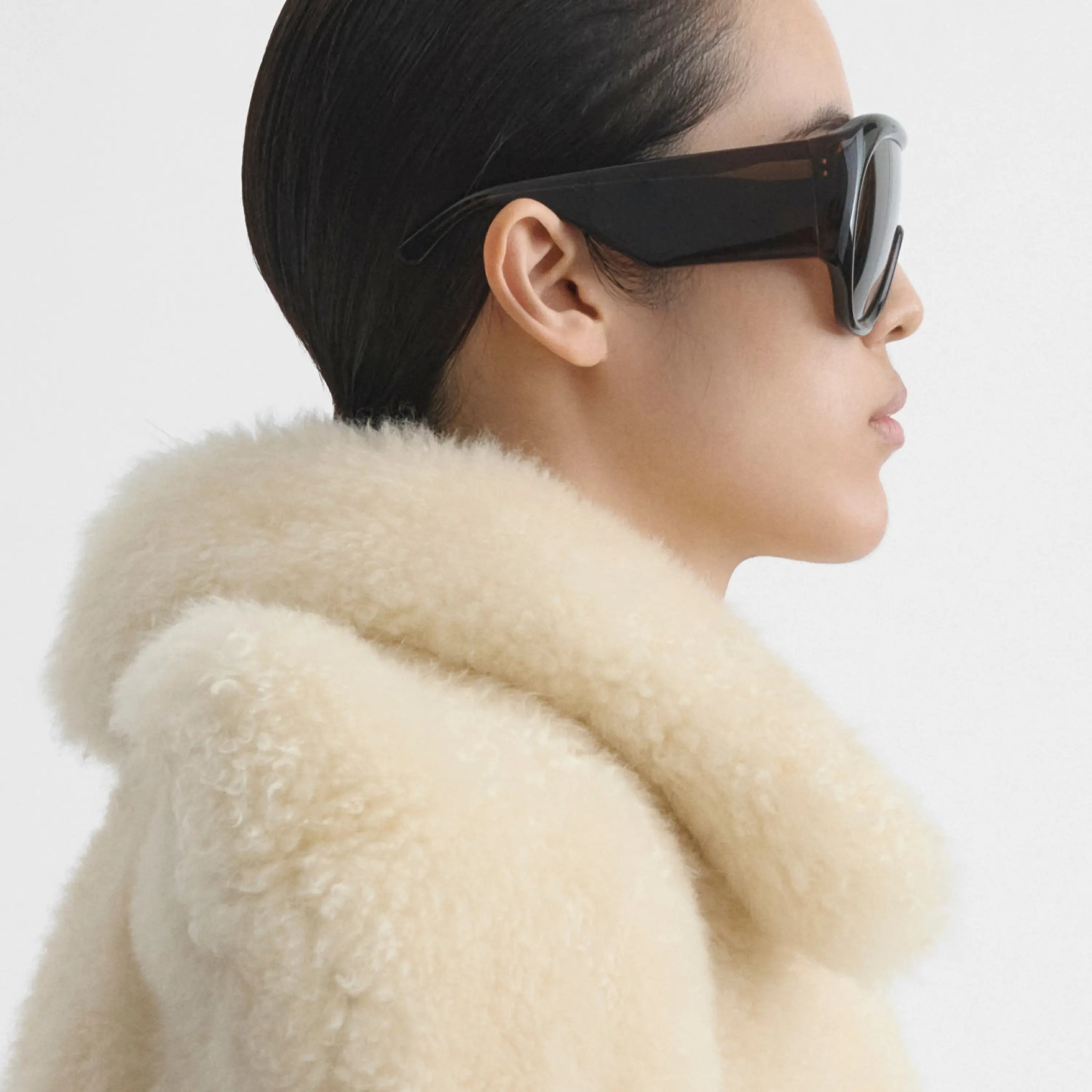 Side view of model wearing bombé sunglasses in brown acetate.