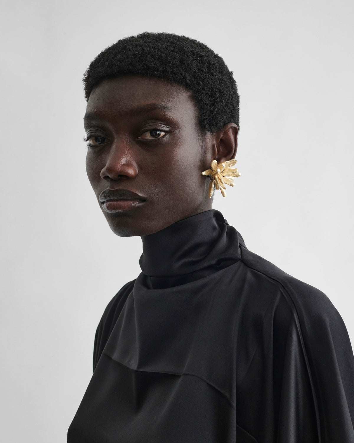 Front view of model wearing CLUSTER EARRINGS in gold
