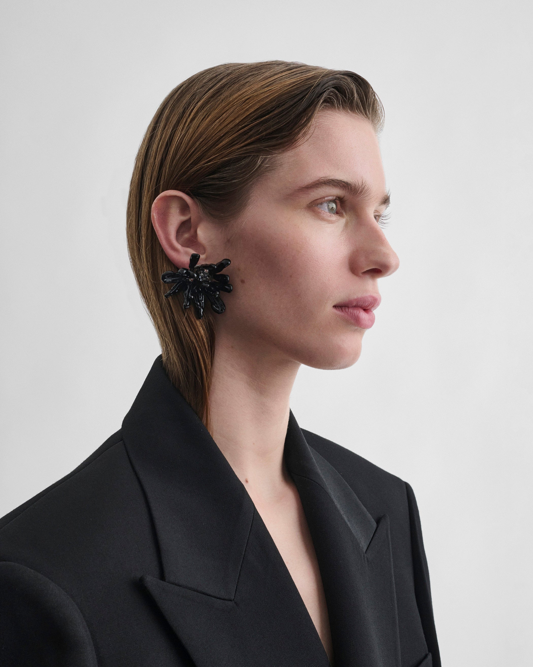 Side view of model wearing CLUSTER EARRINGS in black resin