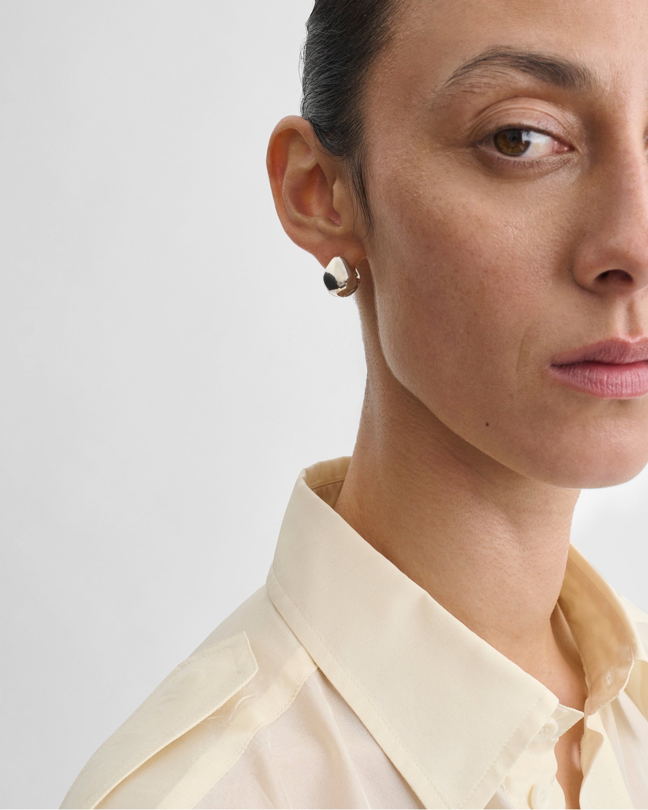 Model wearing PEBBLE STUD EARRINGS in sterling silver