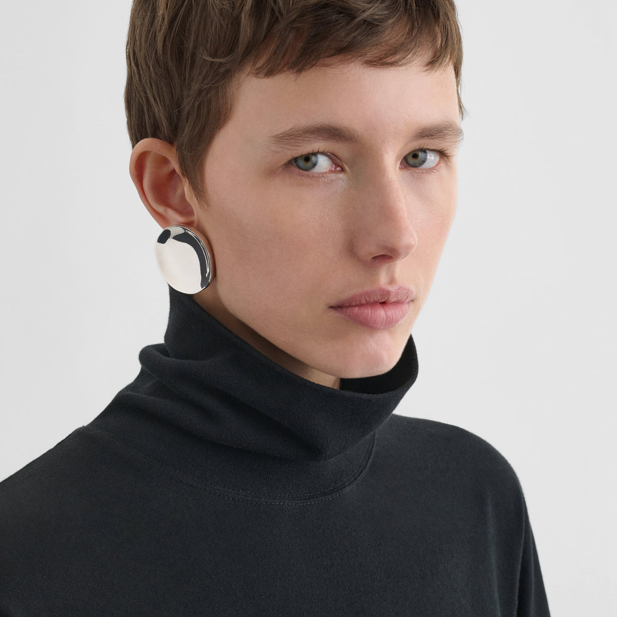 Front view of model wearing MEDALLION DISH EARRINGS in sterling silver