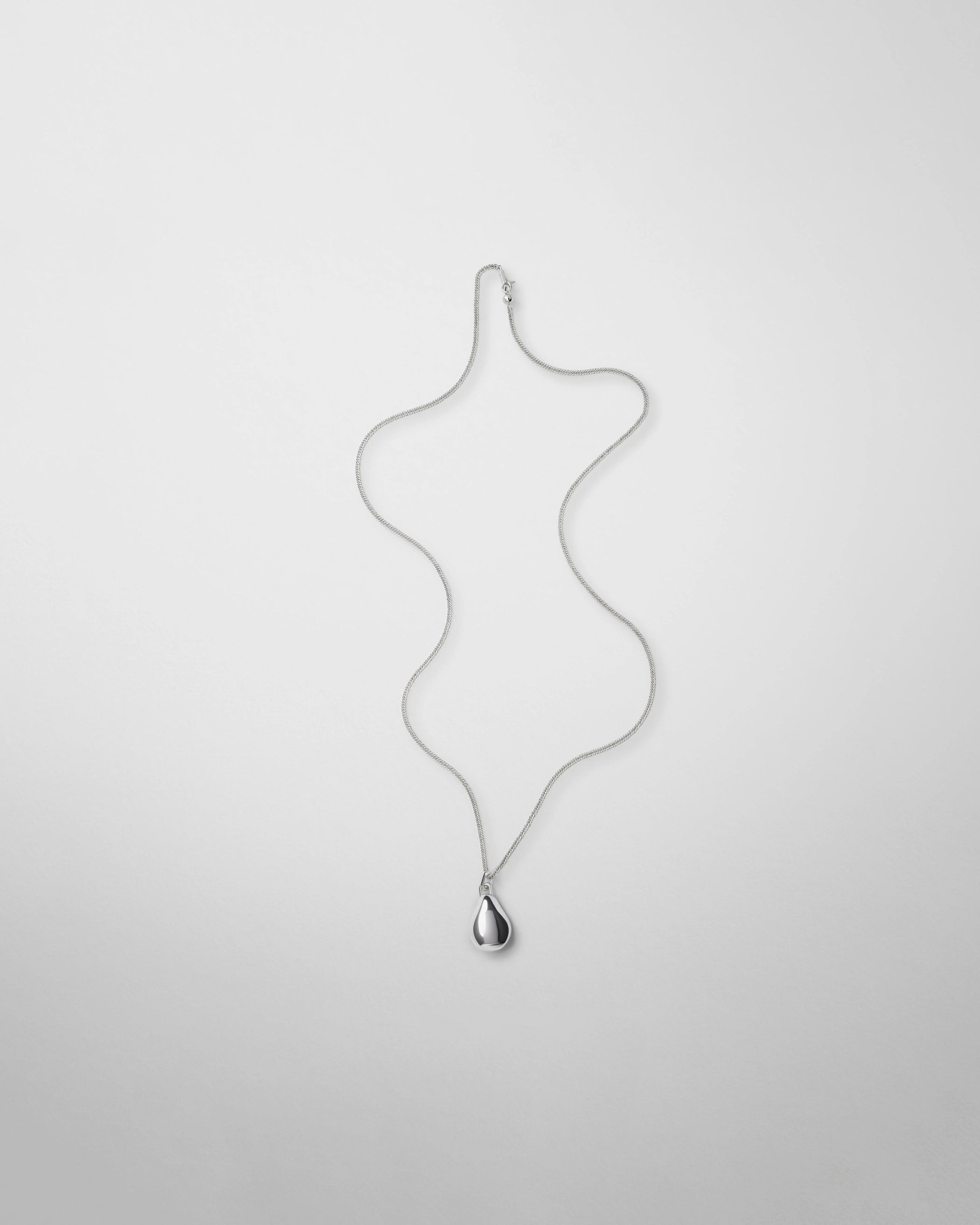 Flat front view of SMALL PEBBLE PENDANT in sterling silver
