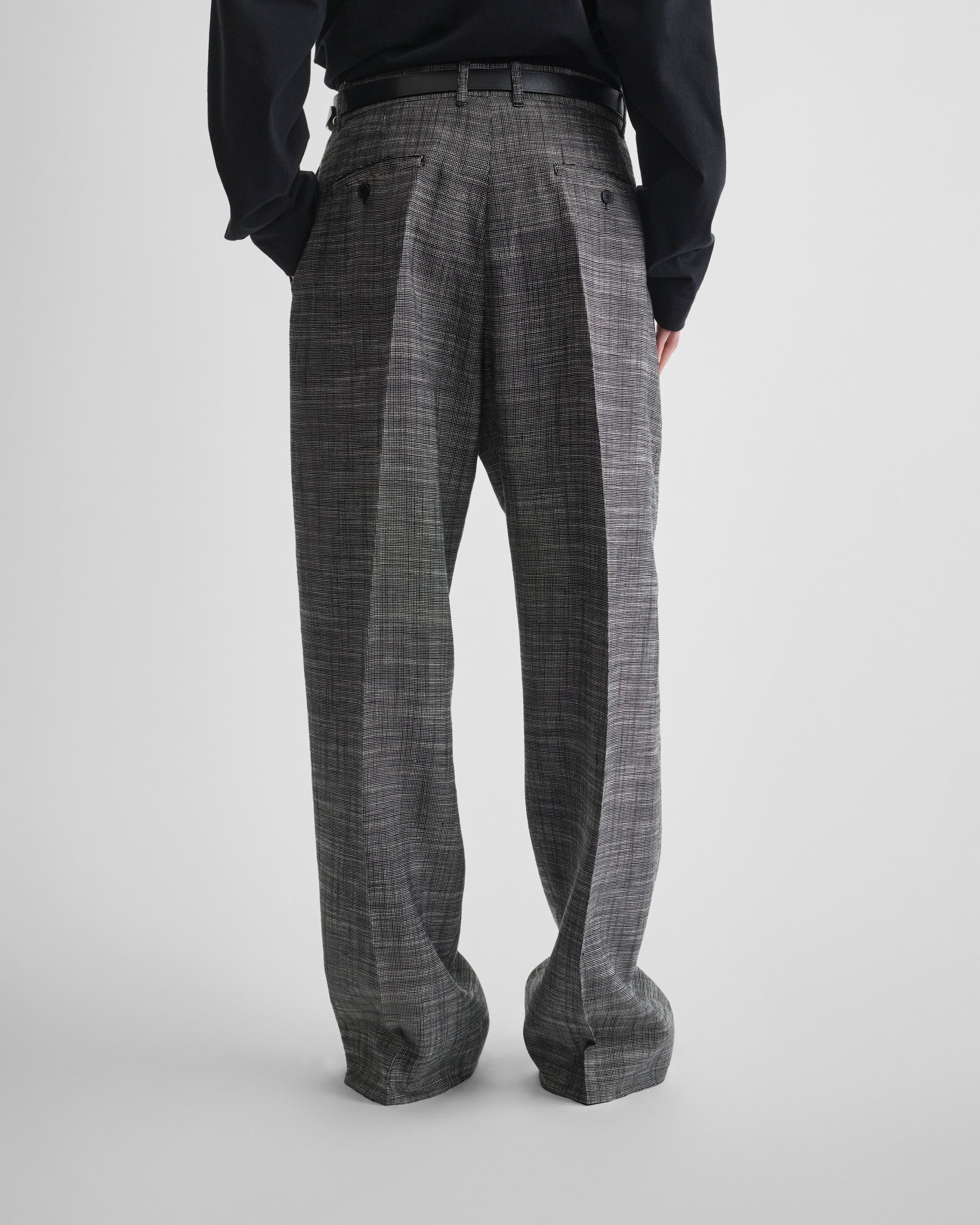 Back view of model wearing DROP TROUSERS in blue grey melange woven viscose