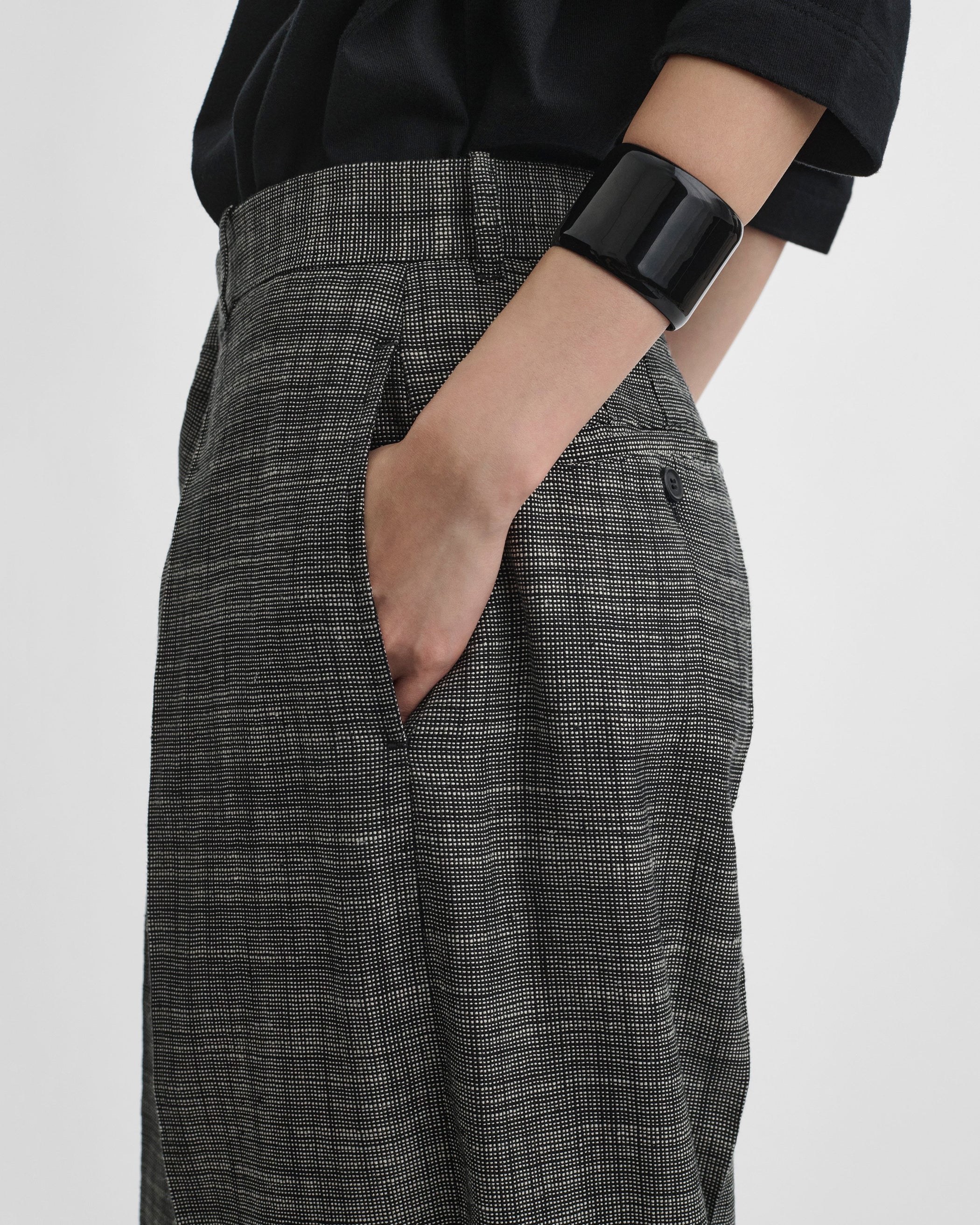 Side detail view of model wearing DROP TROUSERS in blue grey melange woven viscose