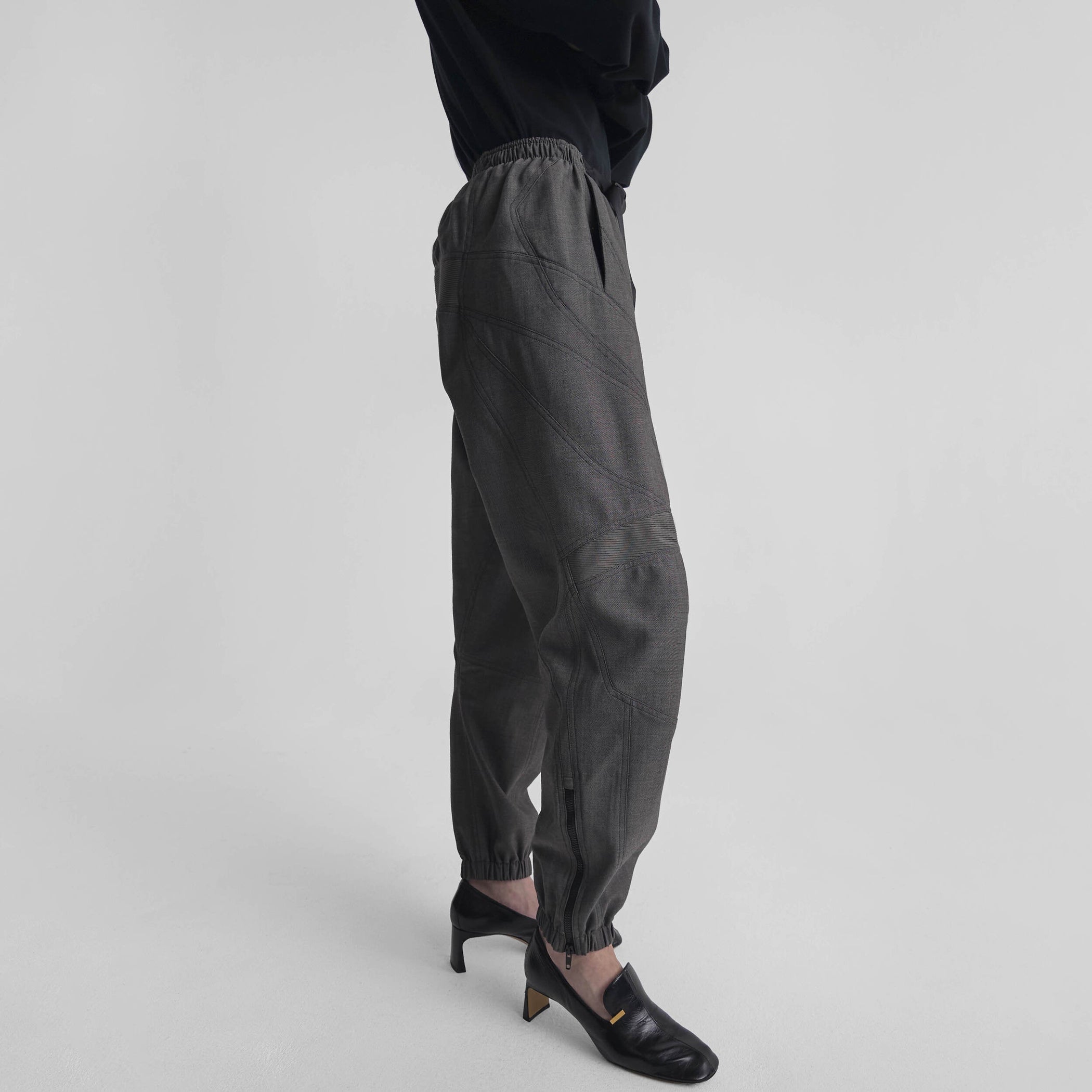 Side view of model wearing BMX TROUSERS in dark taupe wool