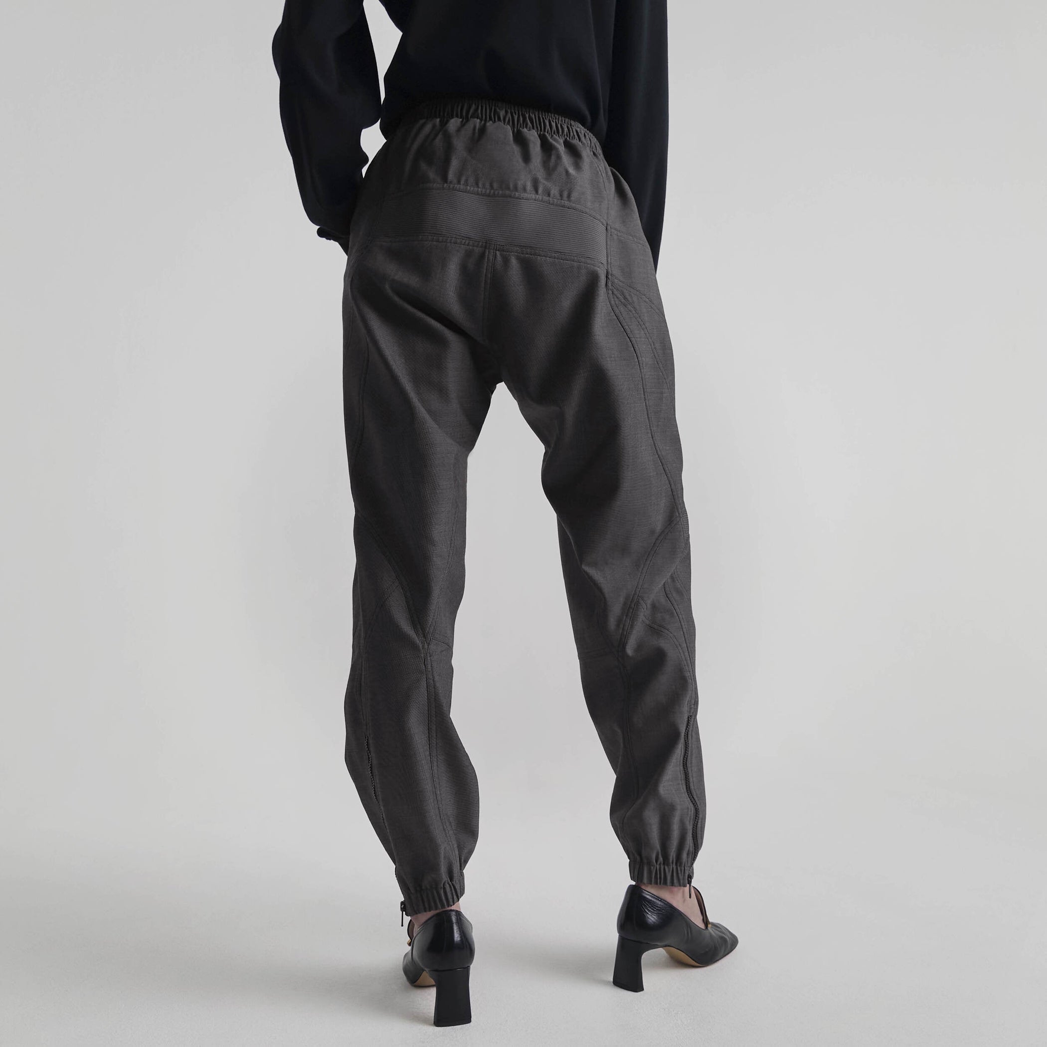 Back view of model wearing BMX TROUSERS in dark taupe wool