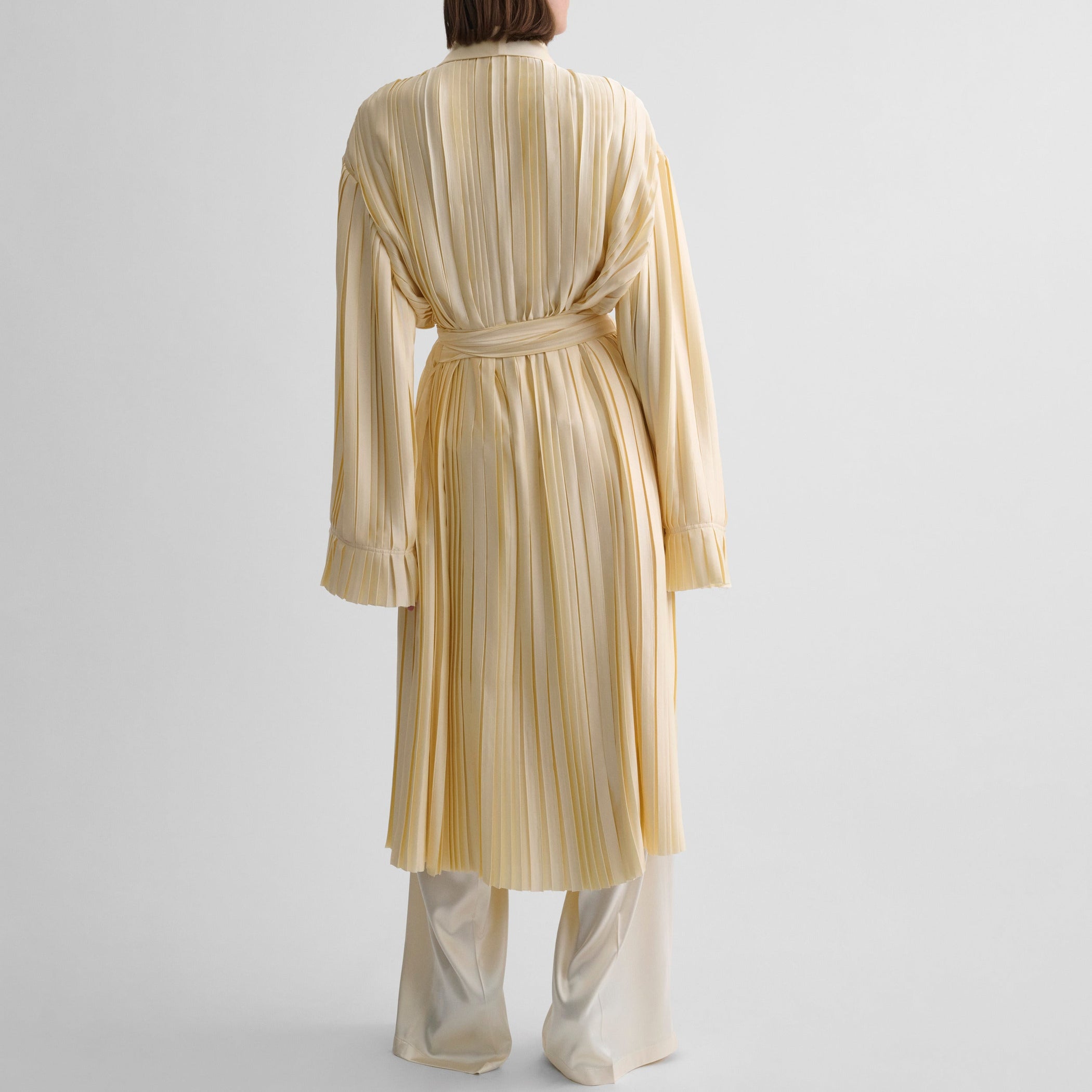 Back view of model wearing PLEATED ROBE in vanilla satin