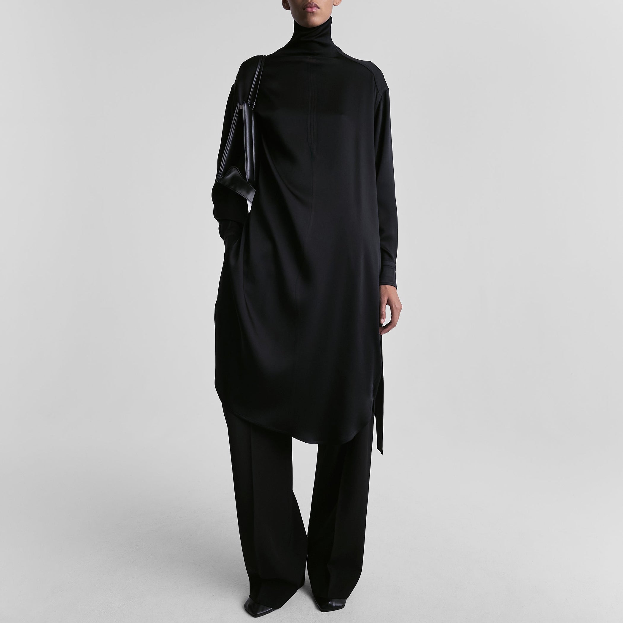 Front view of model wearing DRESS in black satin back crepe