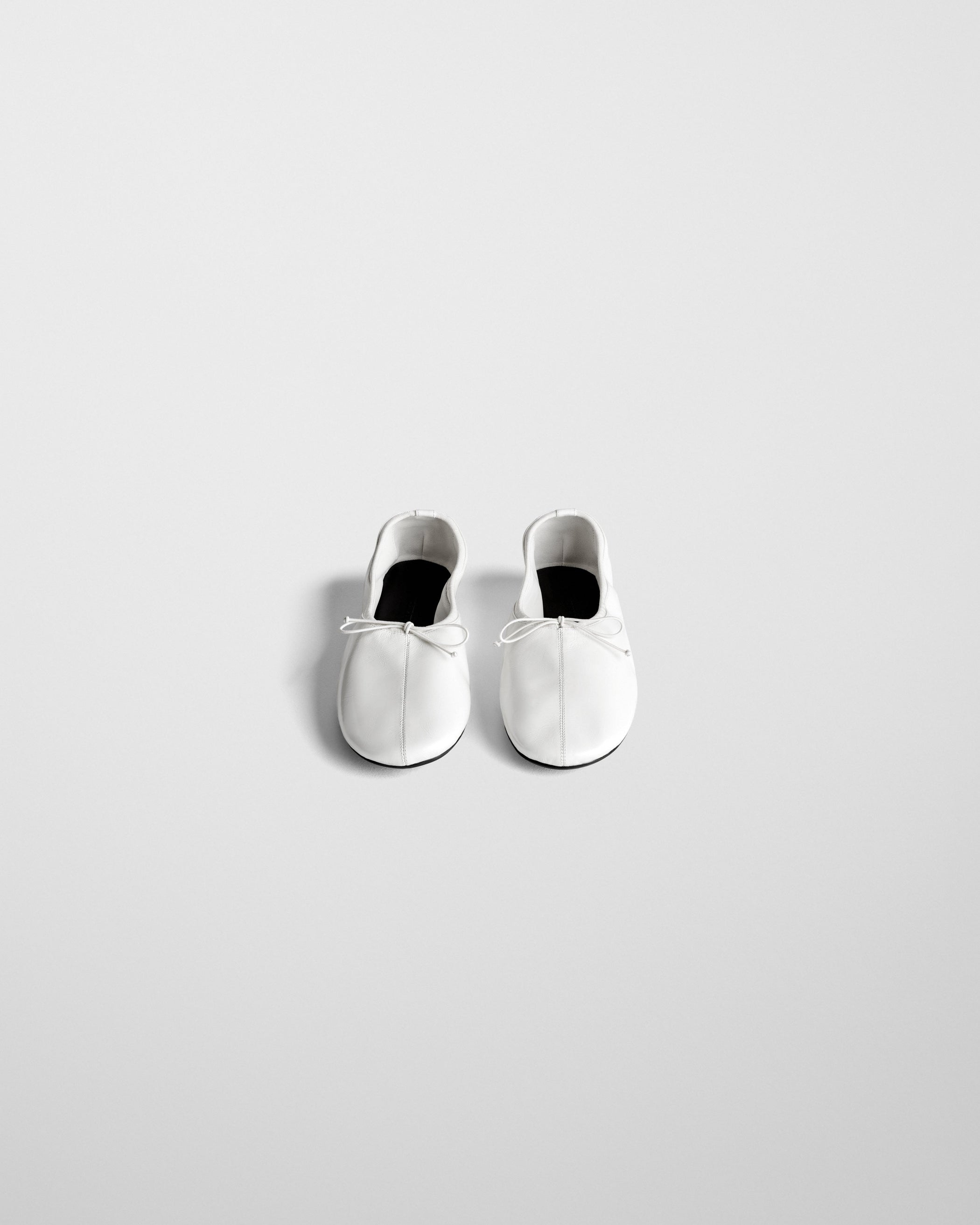 Front view of GATHERED FLAT in white leather