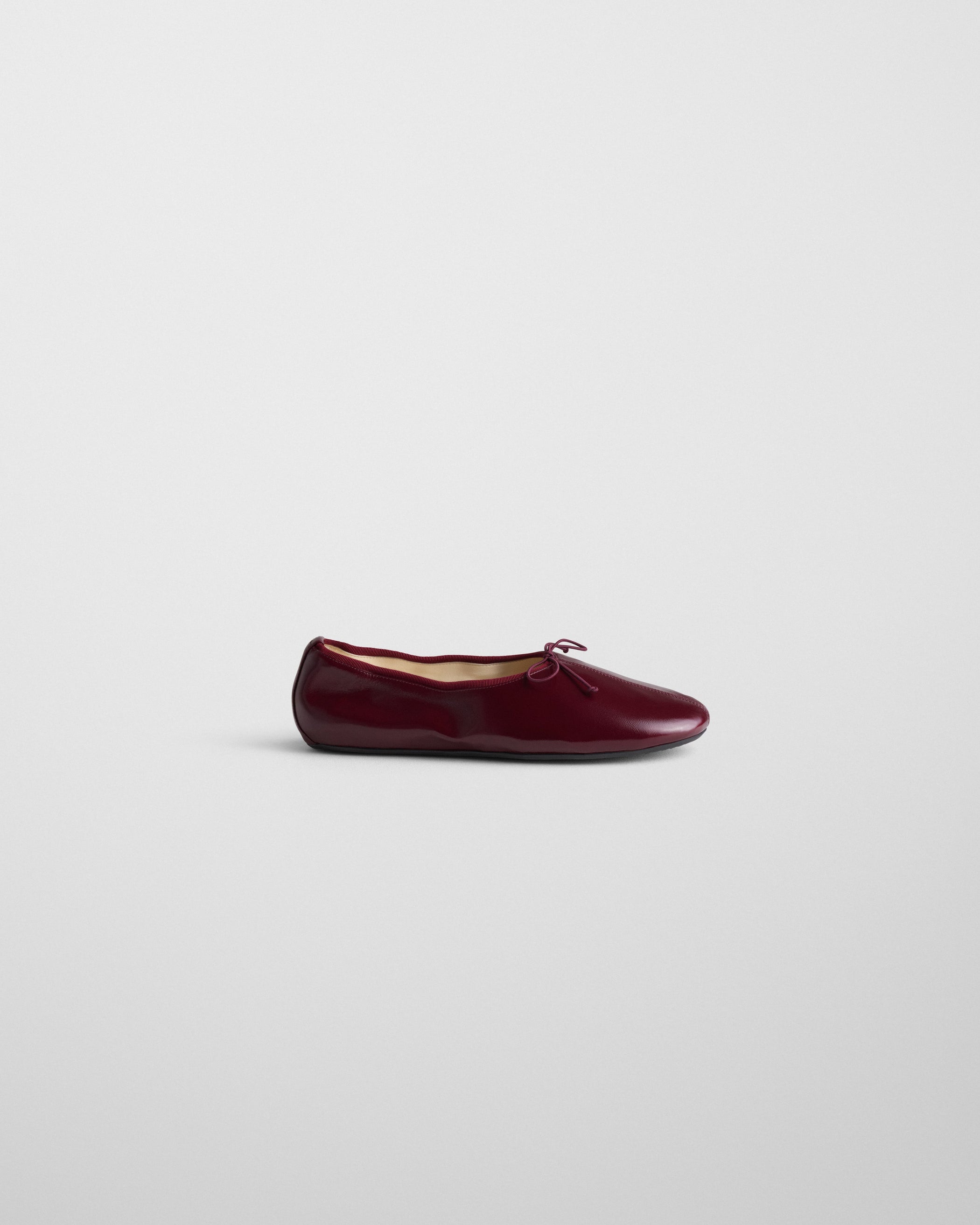 Side view of GATHERED FLAT in merlot leather