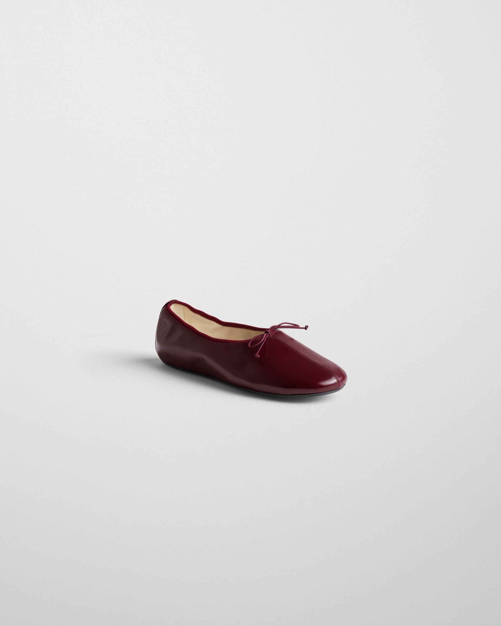 Side view of GATHERED FLAT in merlot leather