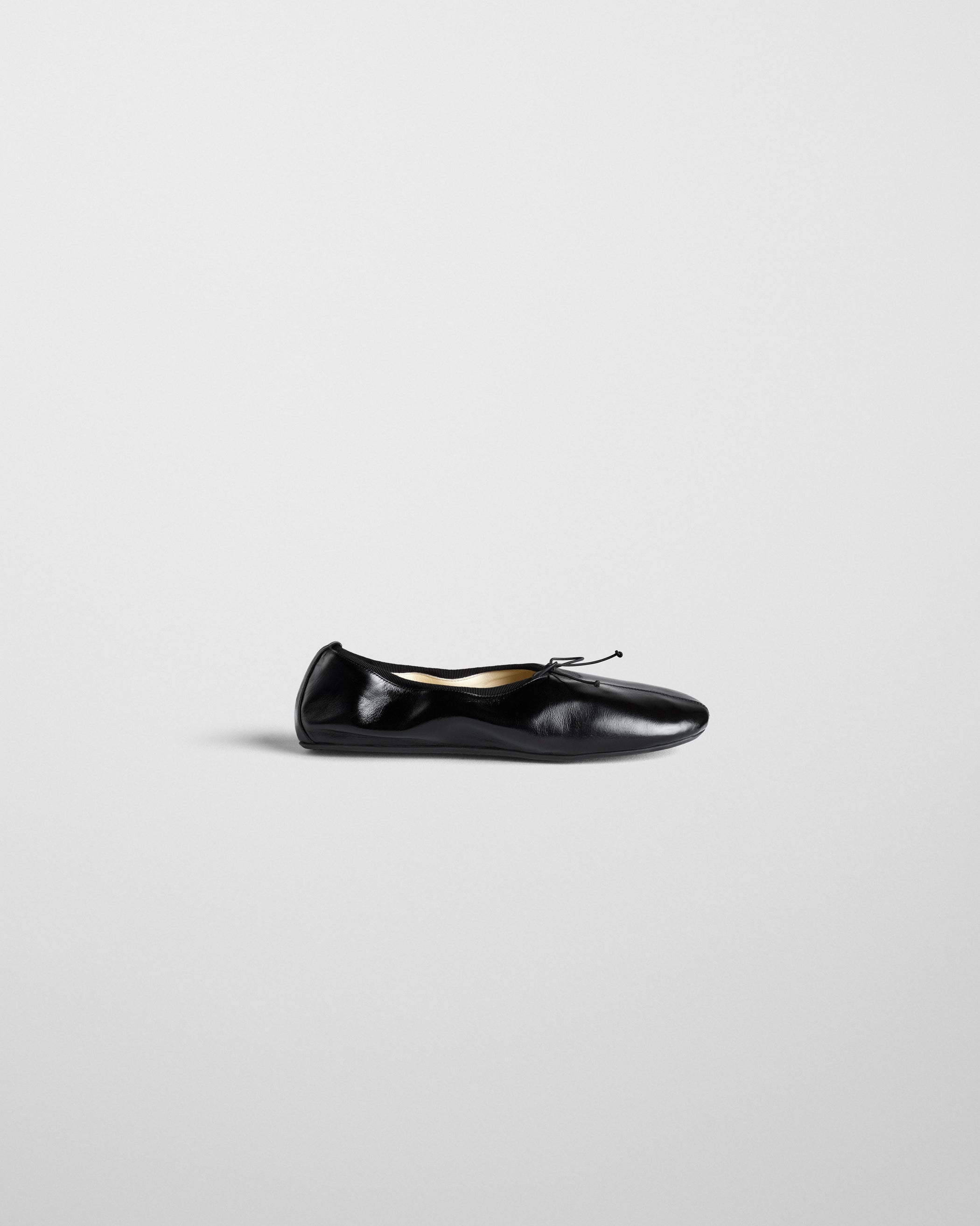 Side view of GATHERED FLAT in black leather