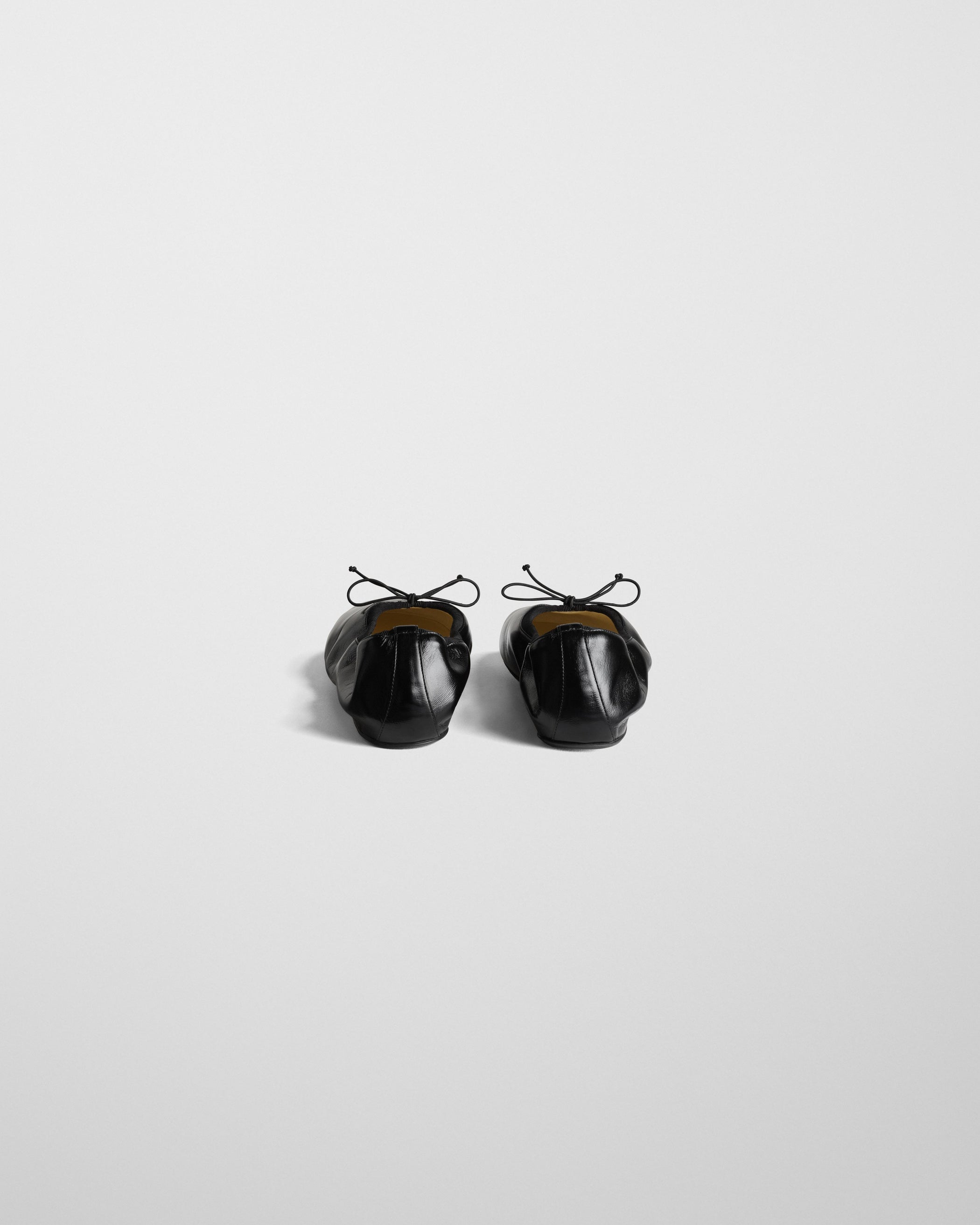 Back view of GATHERED FLAT in black leather