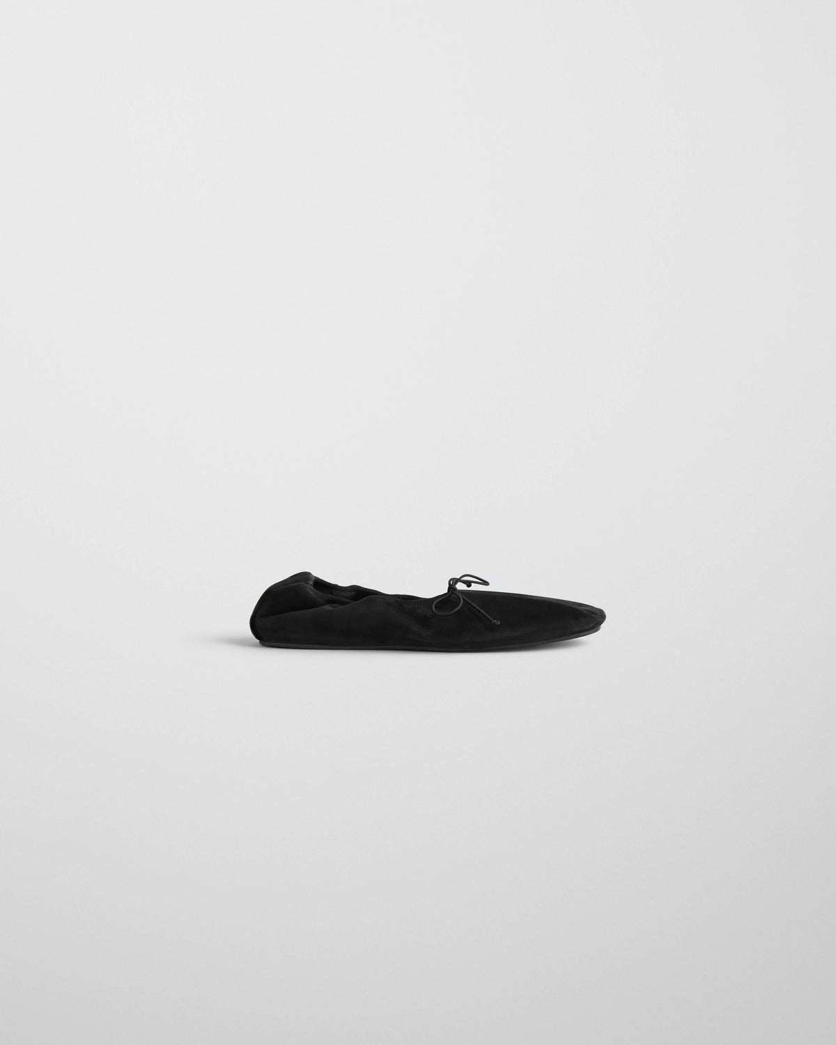Side view of GATHERED FLAT in black suede