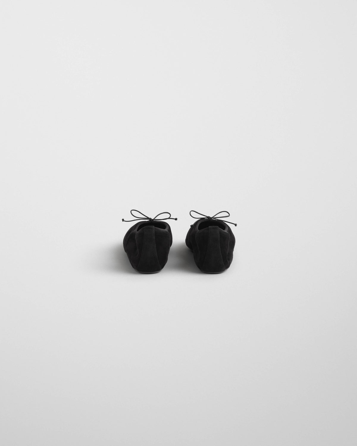 Back view of GATHERED FLAT in black suede