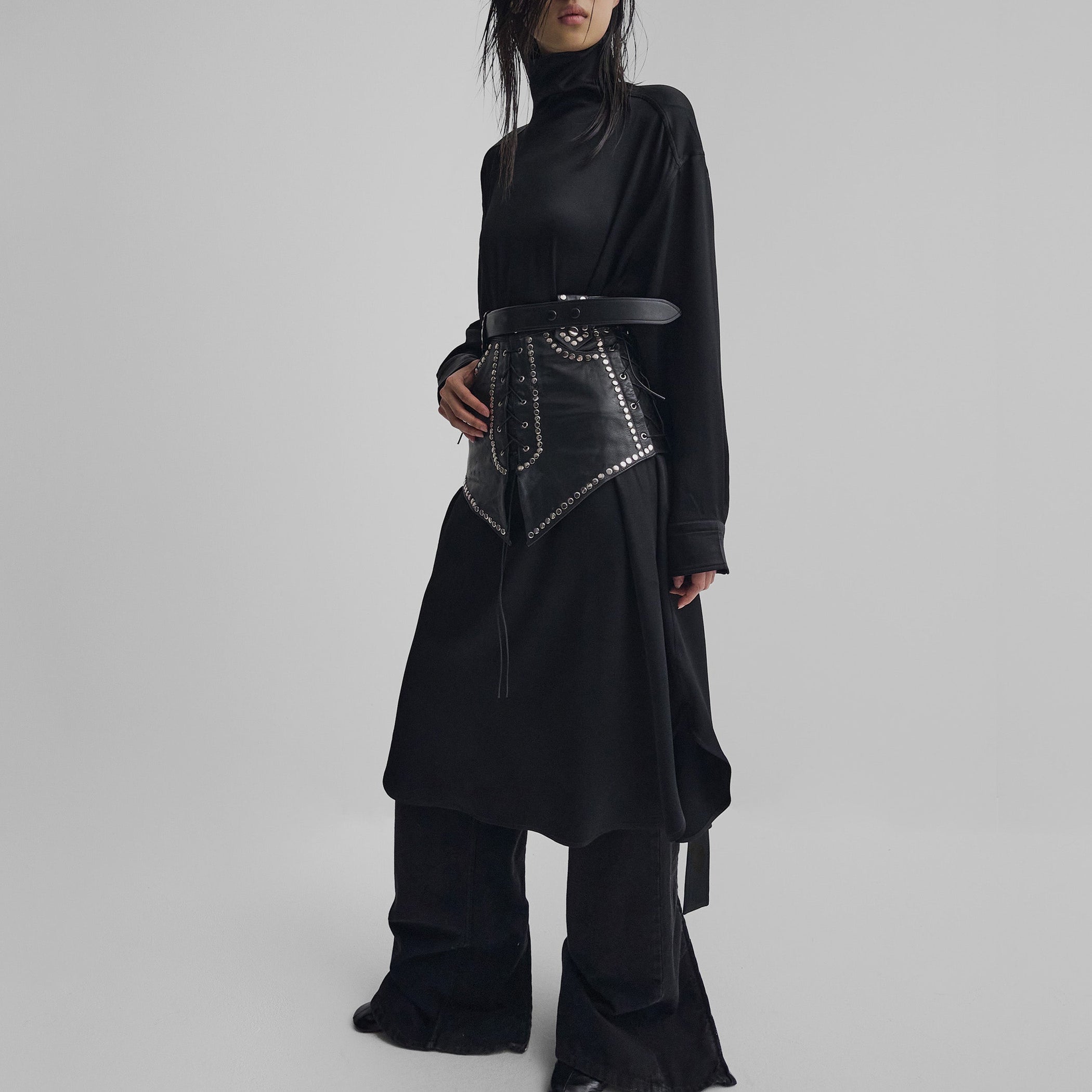 Front view of model wearing STUDDED BELT in black leather