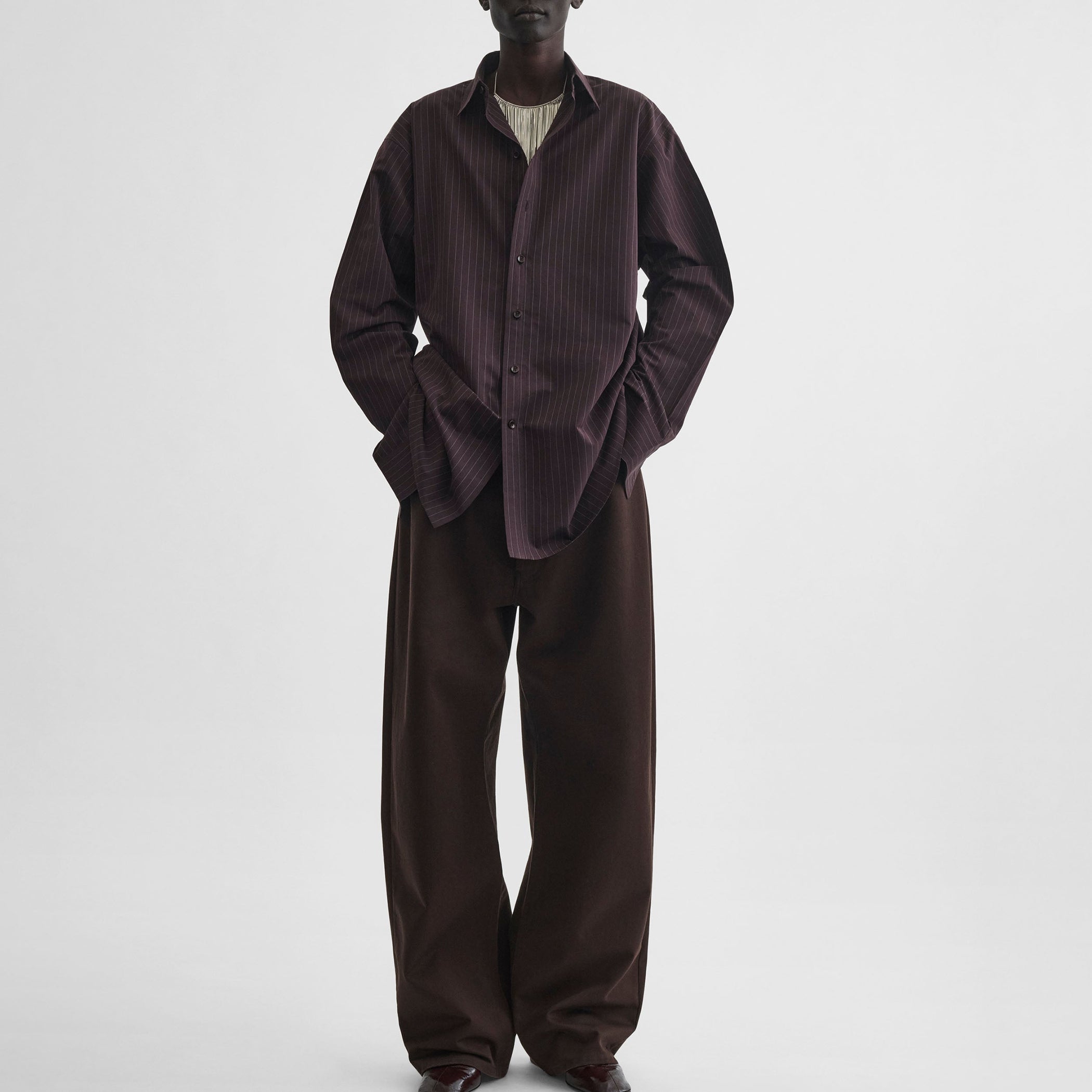 Front view of model wearing sharp collar shirt in black cherry pinstripe cotton