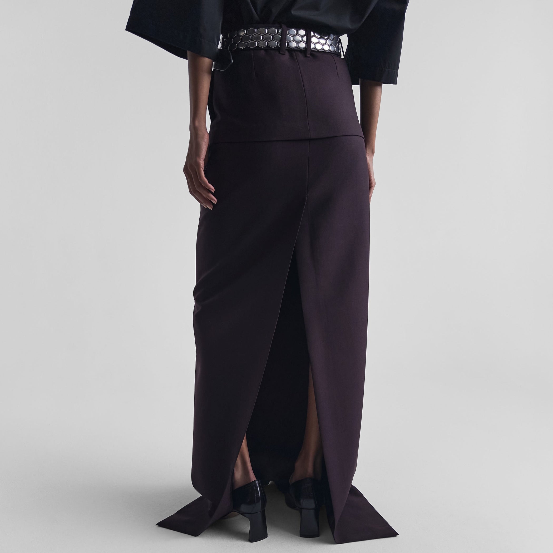 Back view of model wearing HIGH SLIT TAILORED COLUMN SKIRT in berry wool