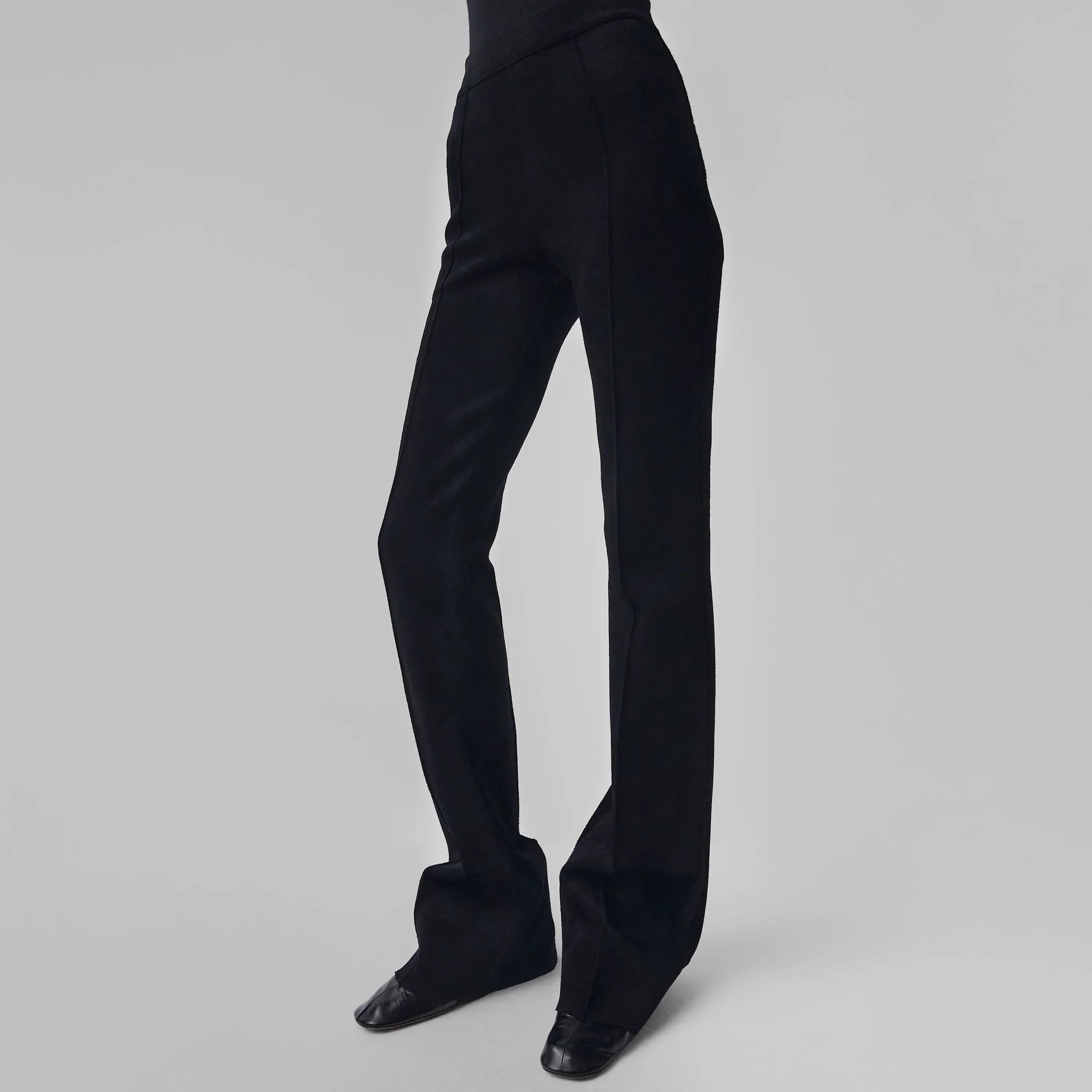 Front view of model wearing CHENILLE TROUSERS in black technical polyester