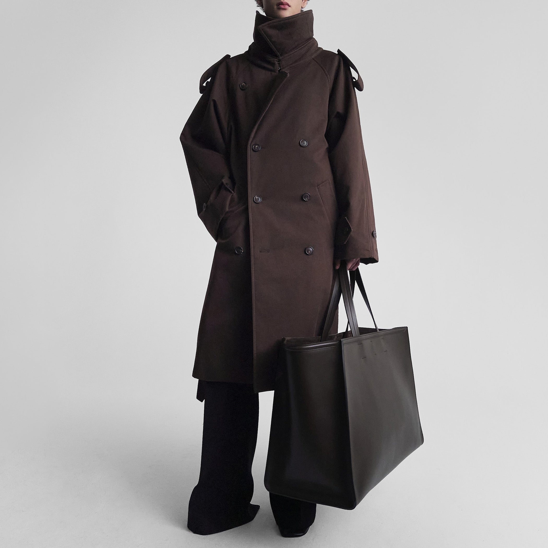 Front view of model wearing PADDED TRENCH COAT in chocolate brown cotton drill
