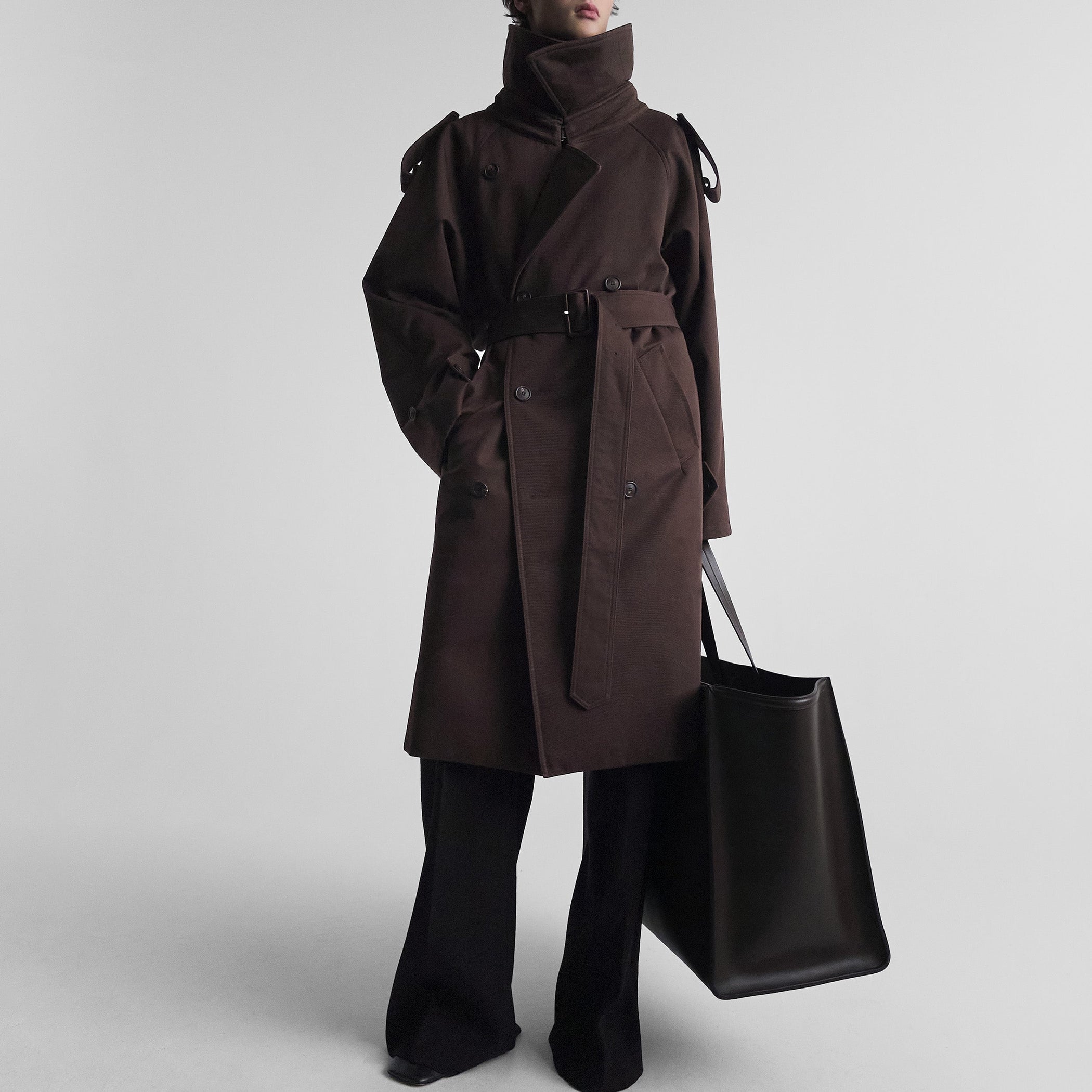 Front view of model wearing PADDED TRENCH COAT in chocolate brown cotton drill
