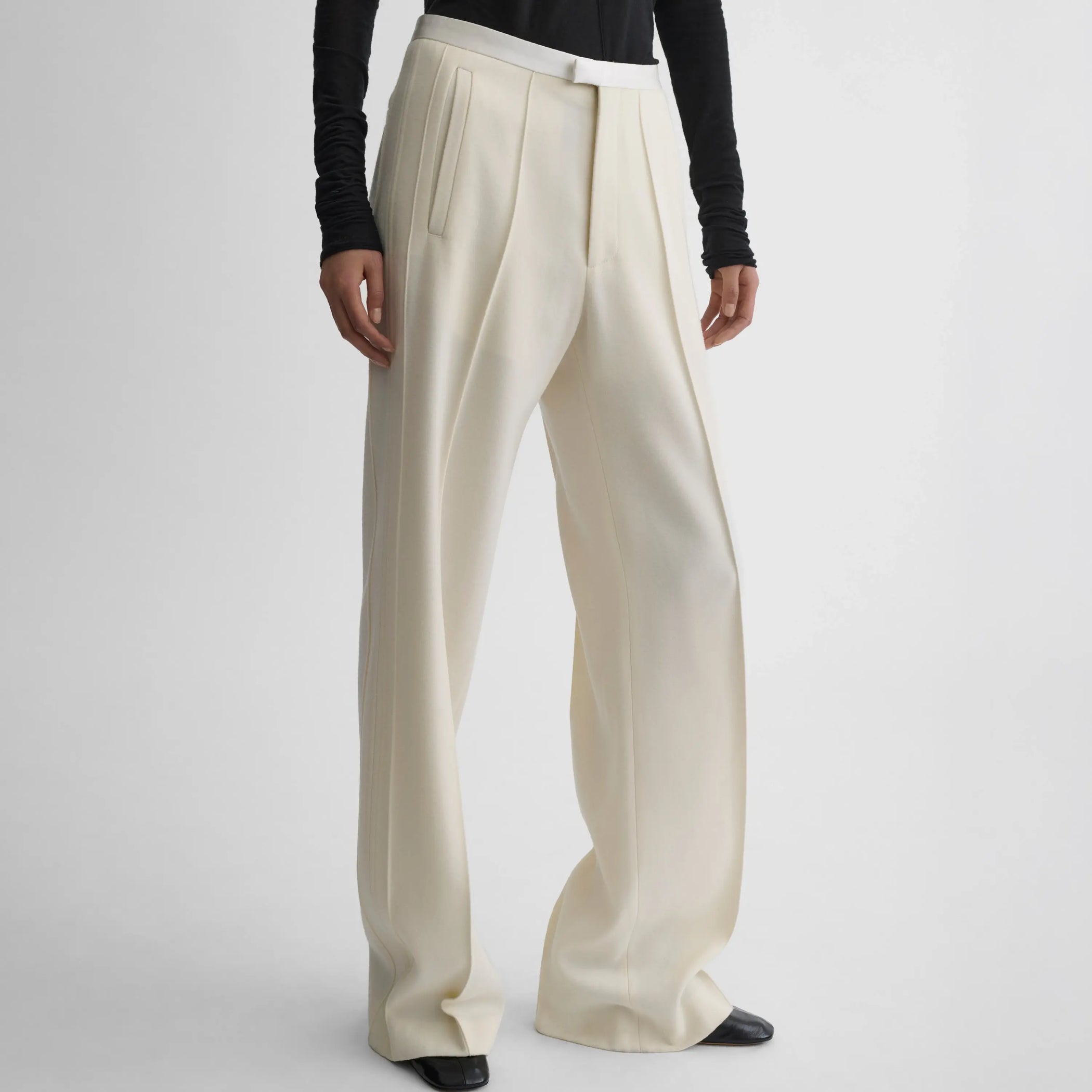 Front view of model wearing Classic Tailored Trousers in cream.