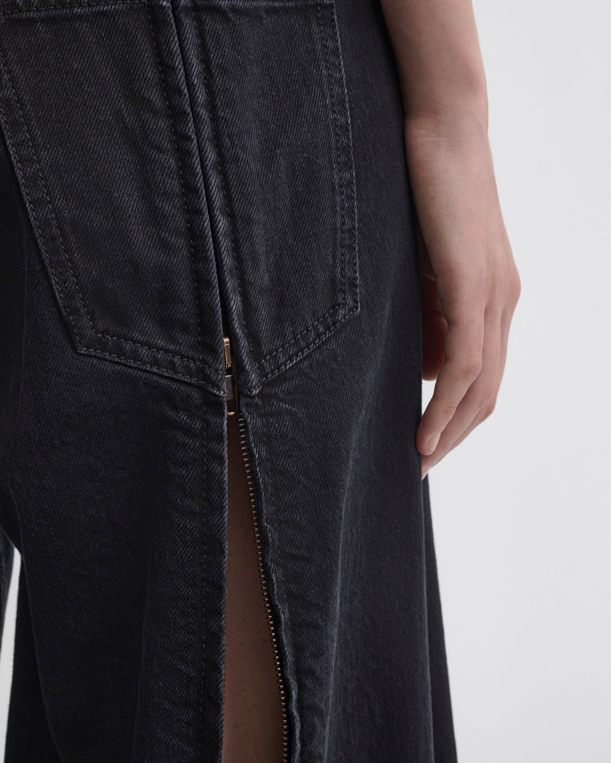 Back detail view of model wearing ZIP JEANS in black cotton