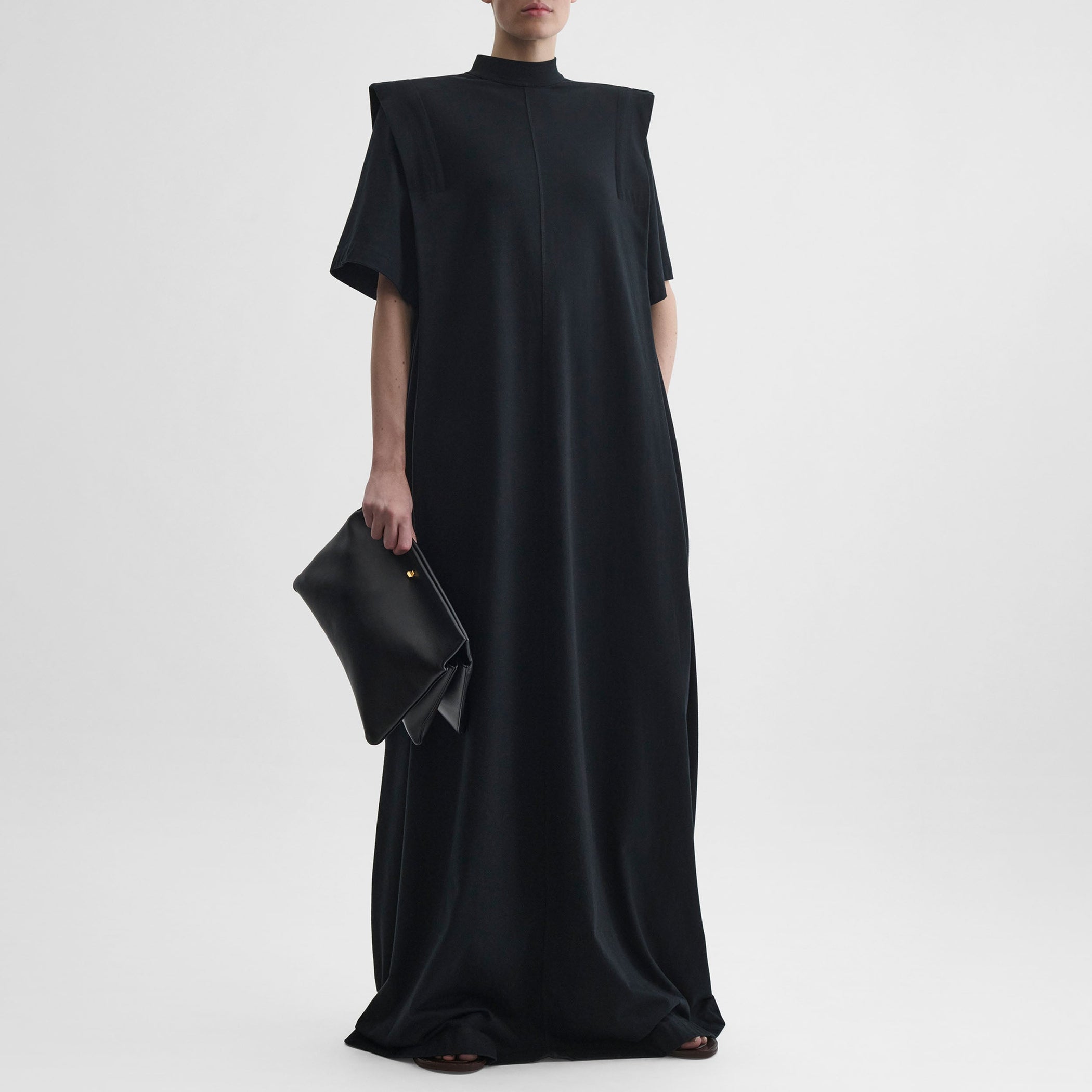 Front view of model wearing FOLDED SHOULDER DRESS in black jersey