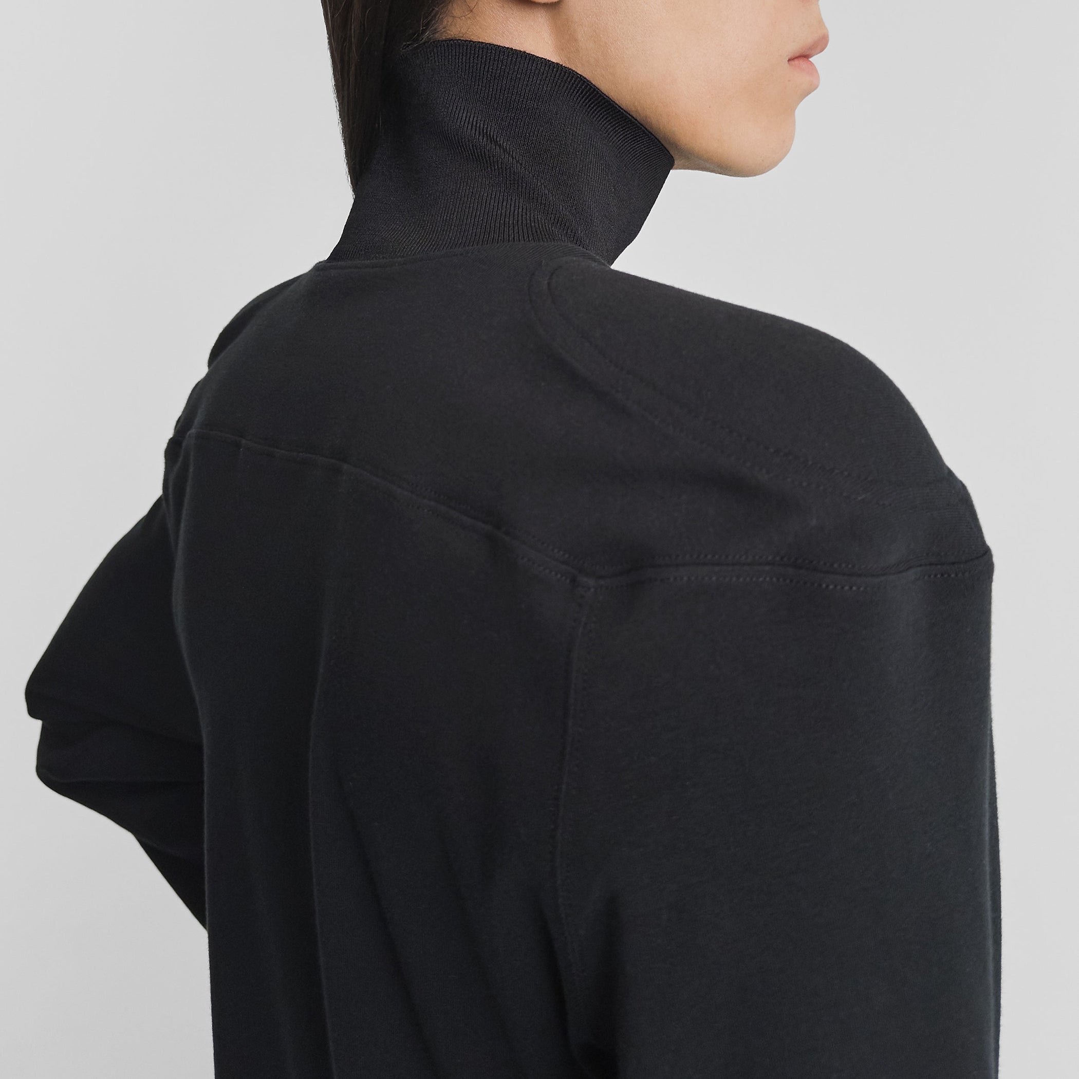 Close up detail view of model wearing SCULPTED T-SHIRT in black cotton jersey