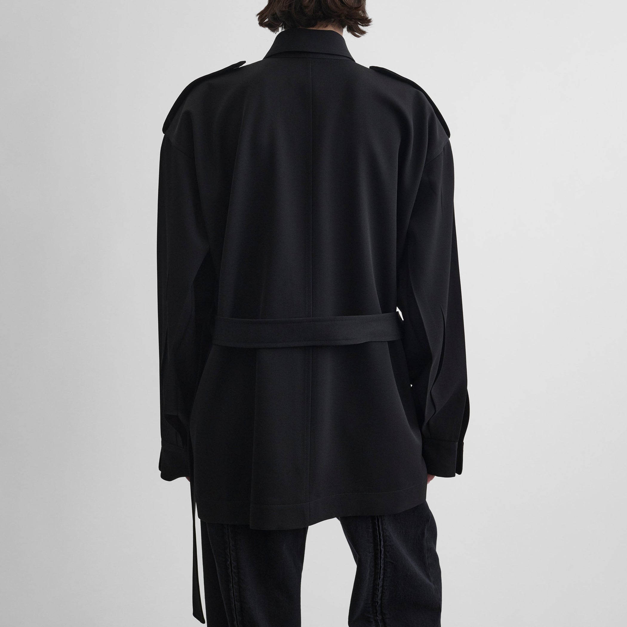 Back view of model wearing LIGHTWEIGHT SHIRT JACKET in black wool