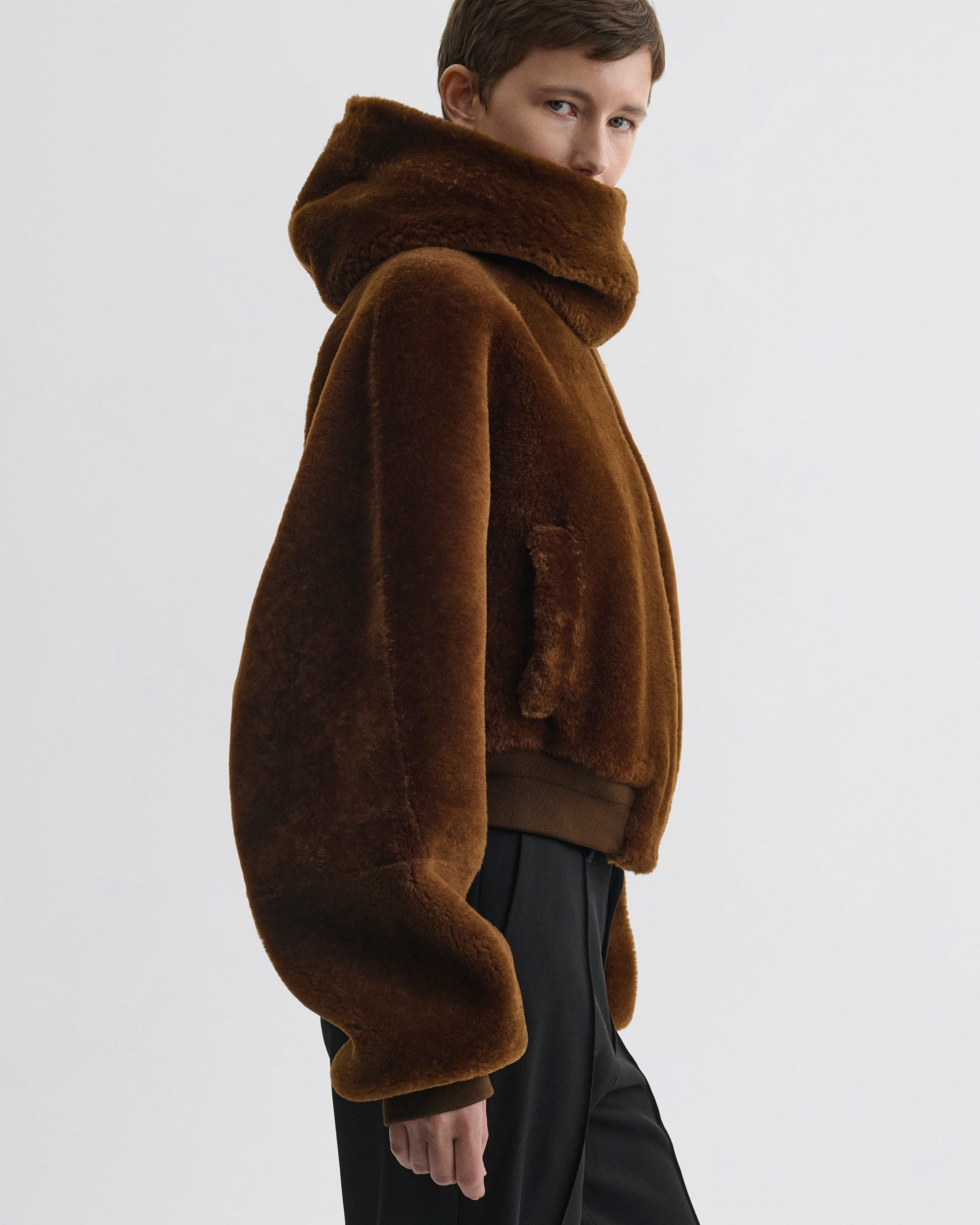 Side view of model wearing Super Soft Bomber Jacket in ginger shearling