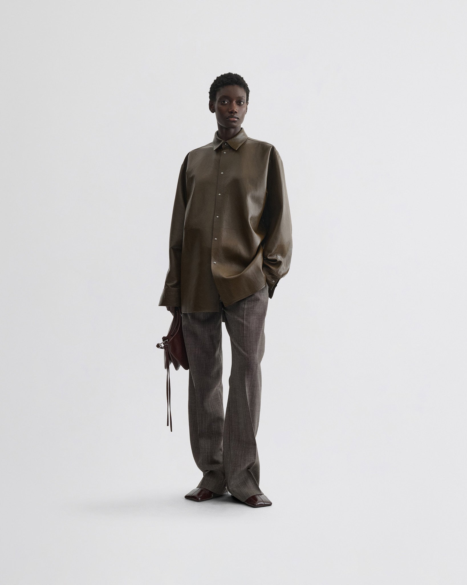 Front view of model wearing overshirt in green bronze leather