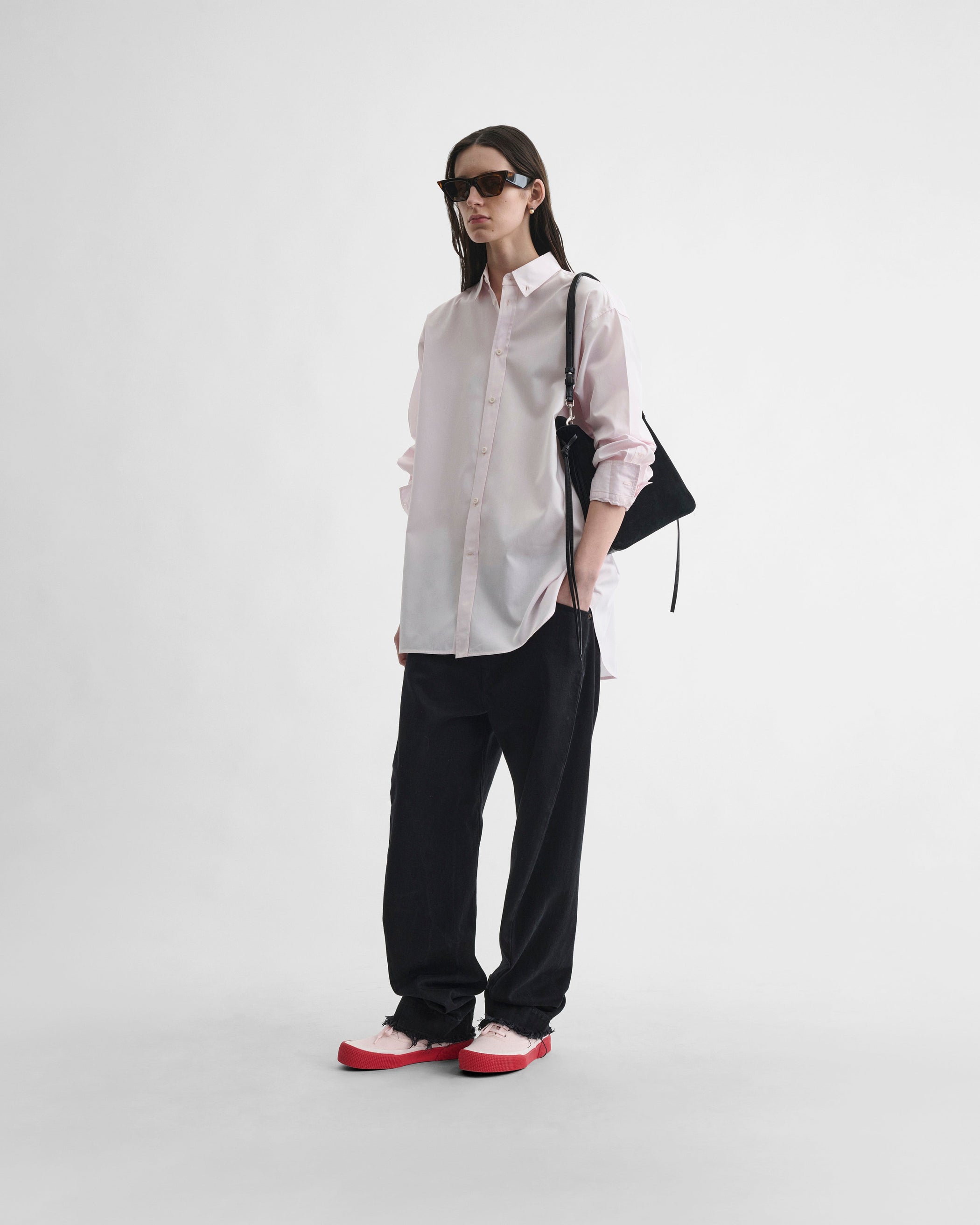 Front view of model wearing BUTTON COLLAR SHIRT in pale pink cotton