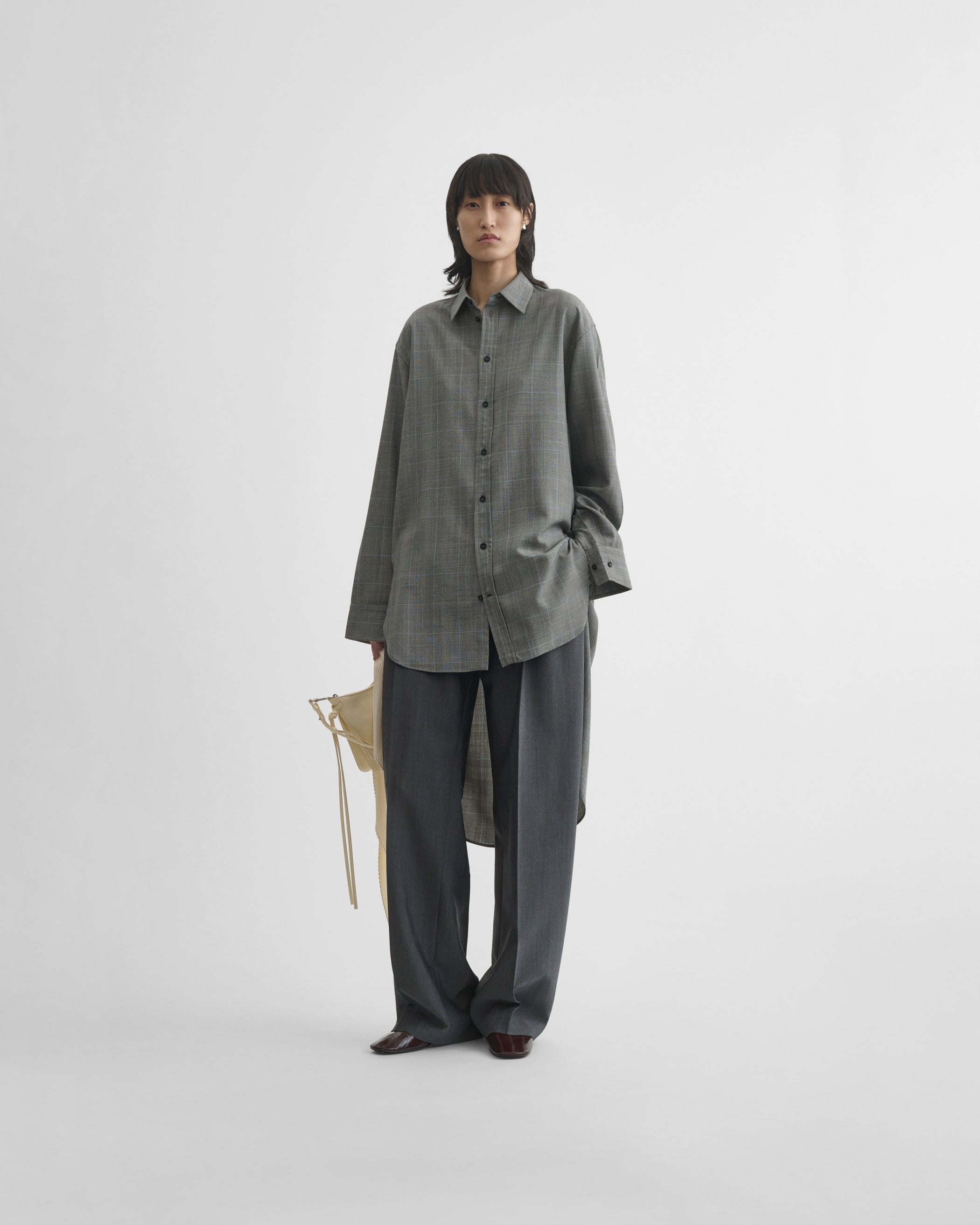 View of elongated shirt in black-blue wool