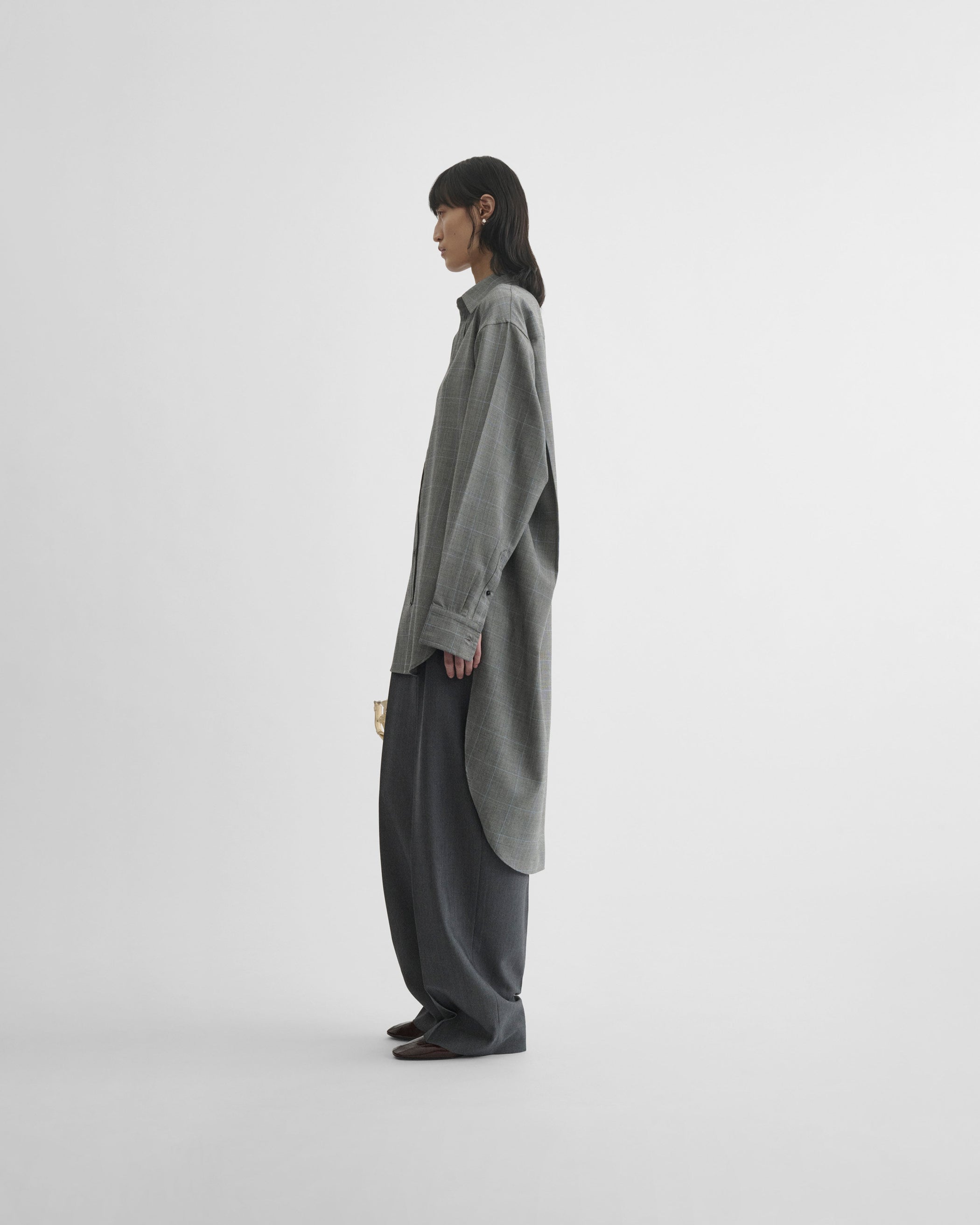 View of elongated shirt in black-blue wool