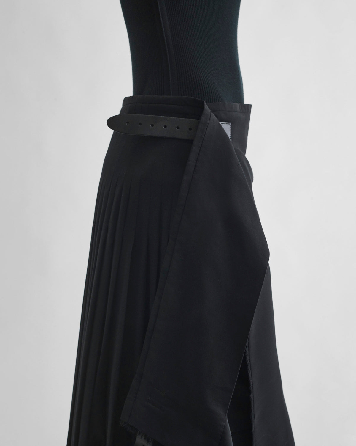 Side detail view of model wearing KILT in black wool