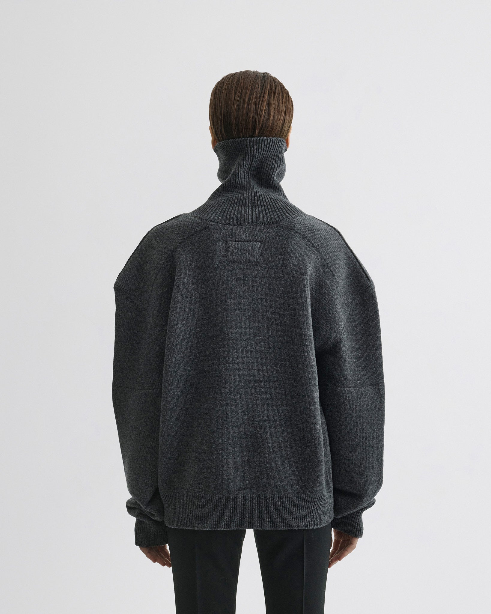 Back view of model wearing Patch Shoulder Jumper in grey melange wool cashmere