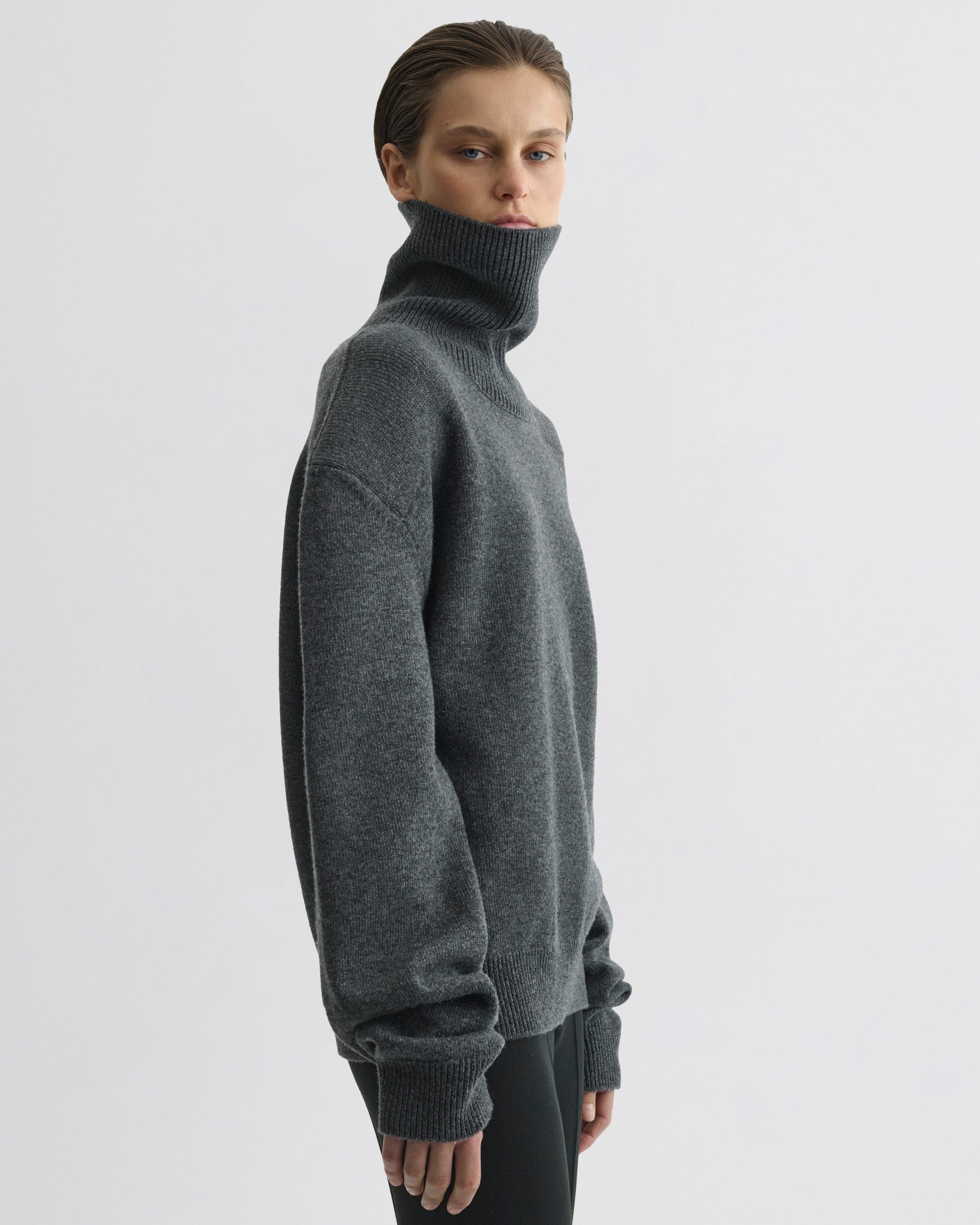 Side view of model wearing Patch Shoulder Jumper in grey melange wool cashmere